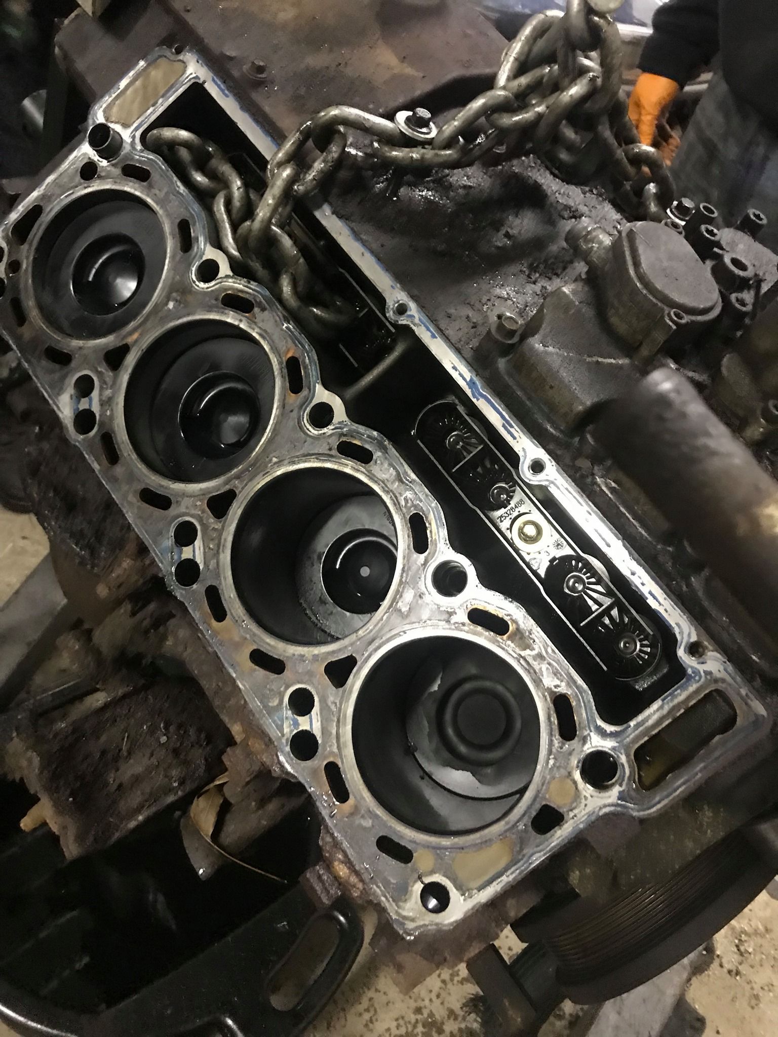 Engine block with a removed cylinder head, showing piston cylinders.