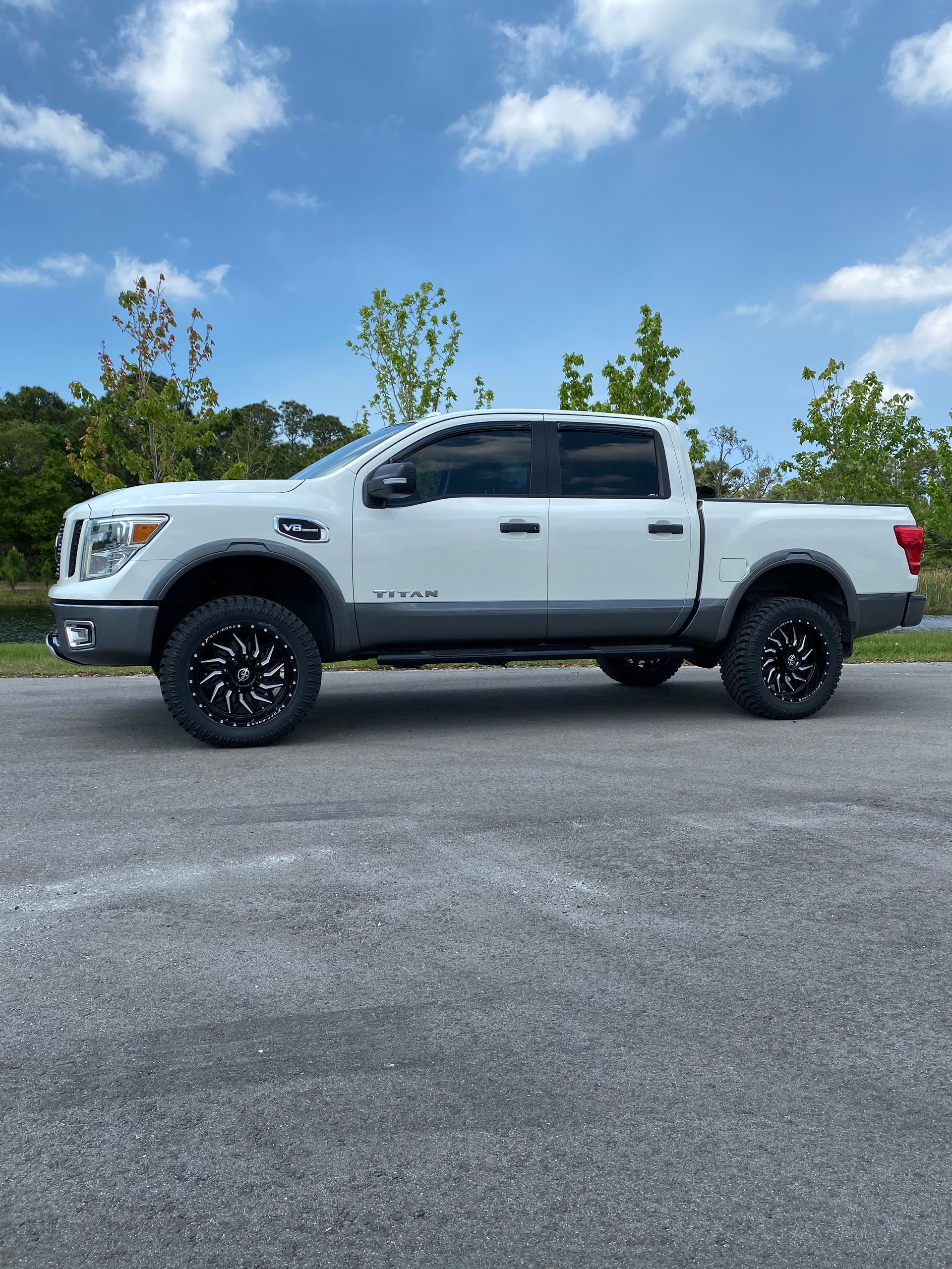 A white truck is parked on the side of the road.