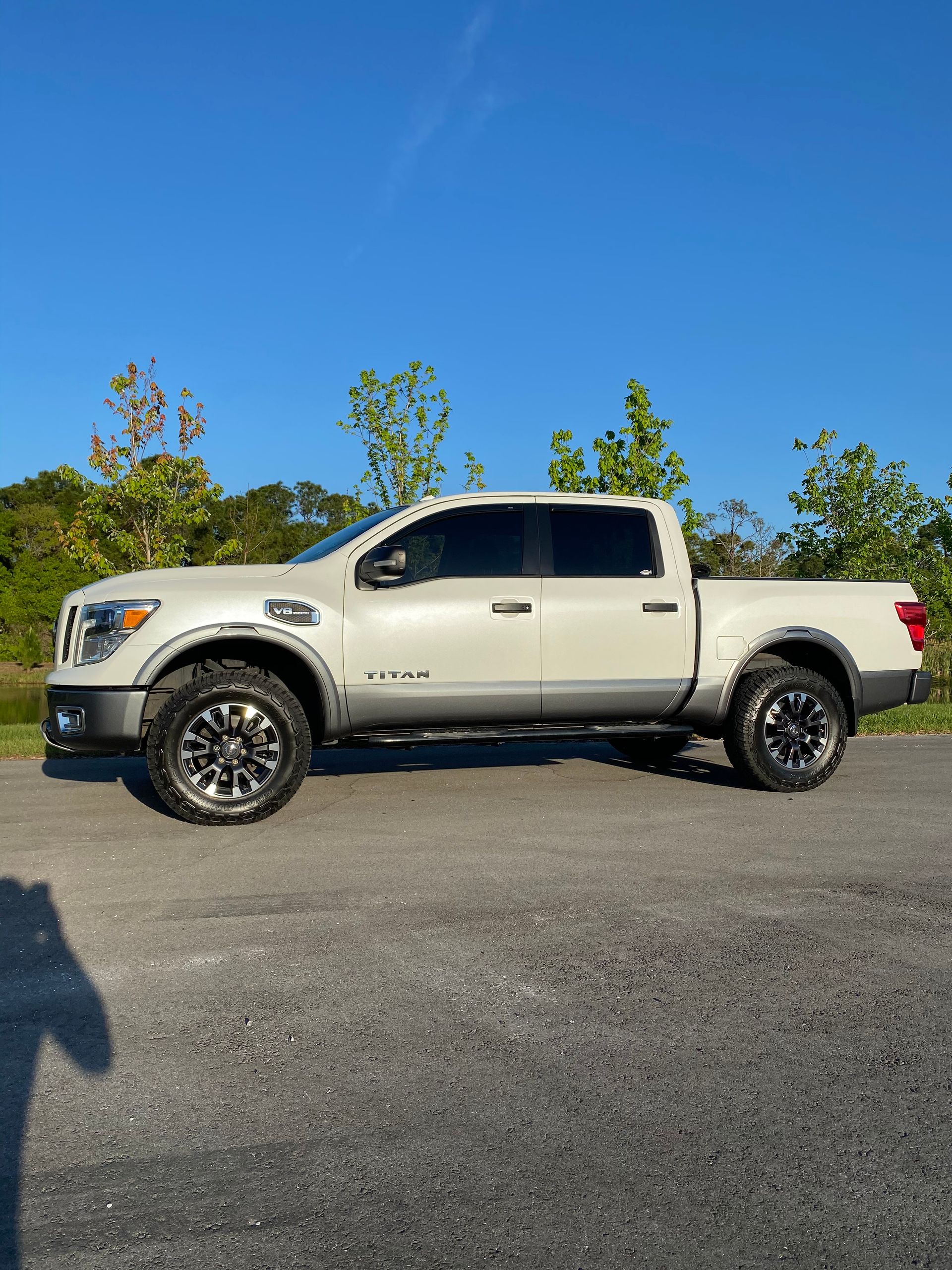 A white truck is parked on the side of the road.