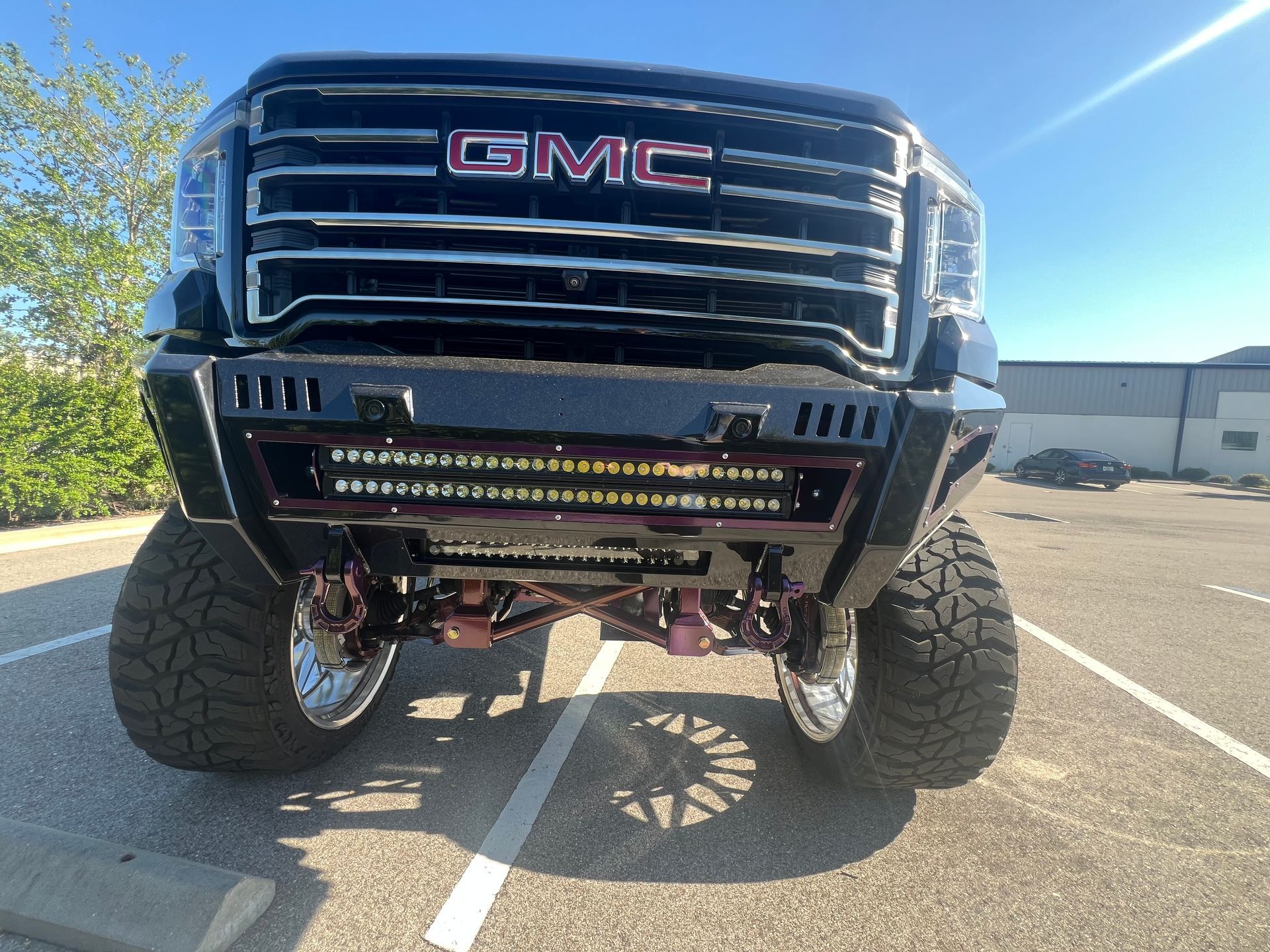 A gmc truck is parked in a parking lot.