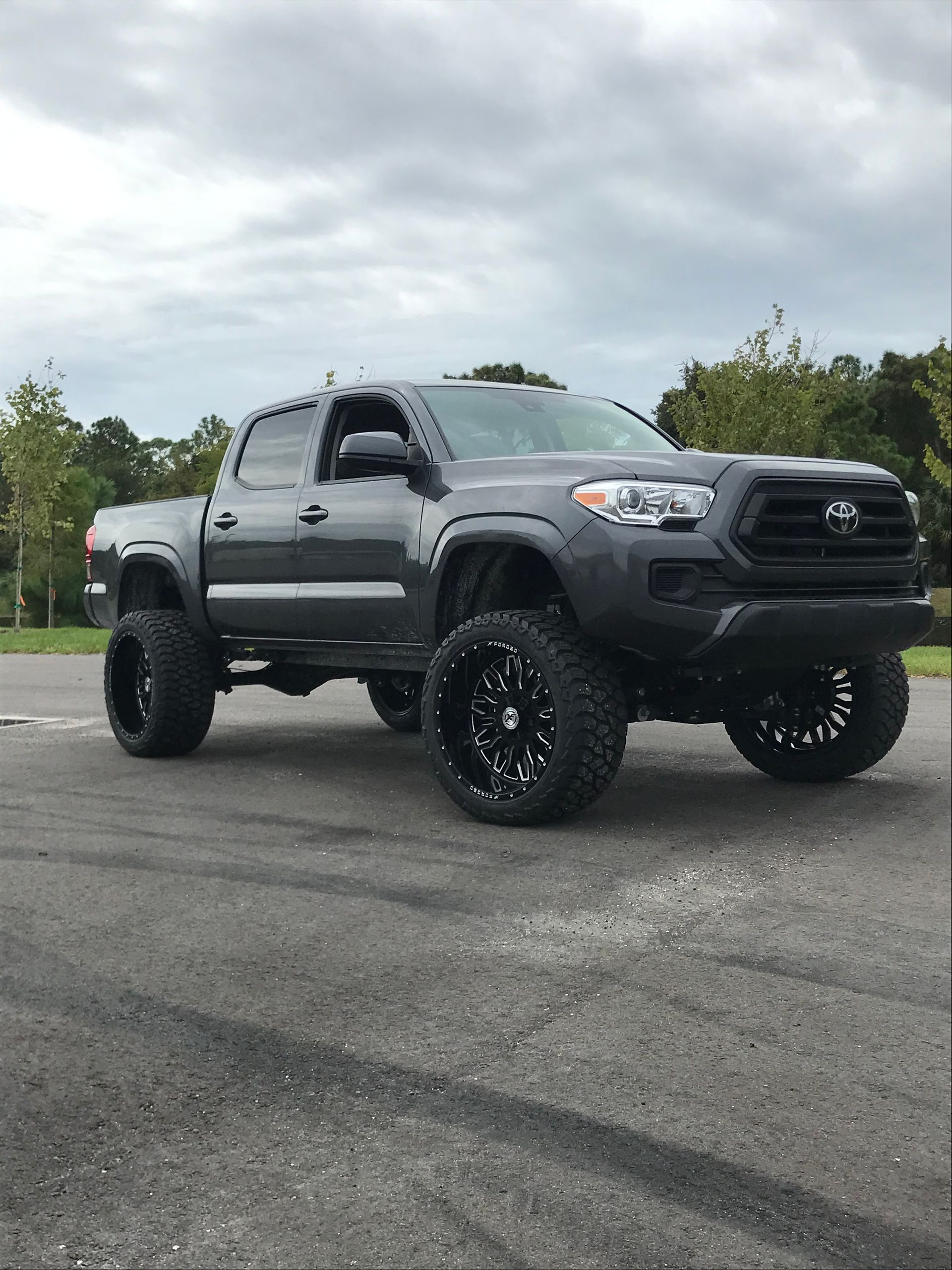 A toyota tacoma truck is parked on the side of the road.