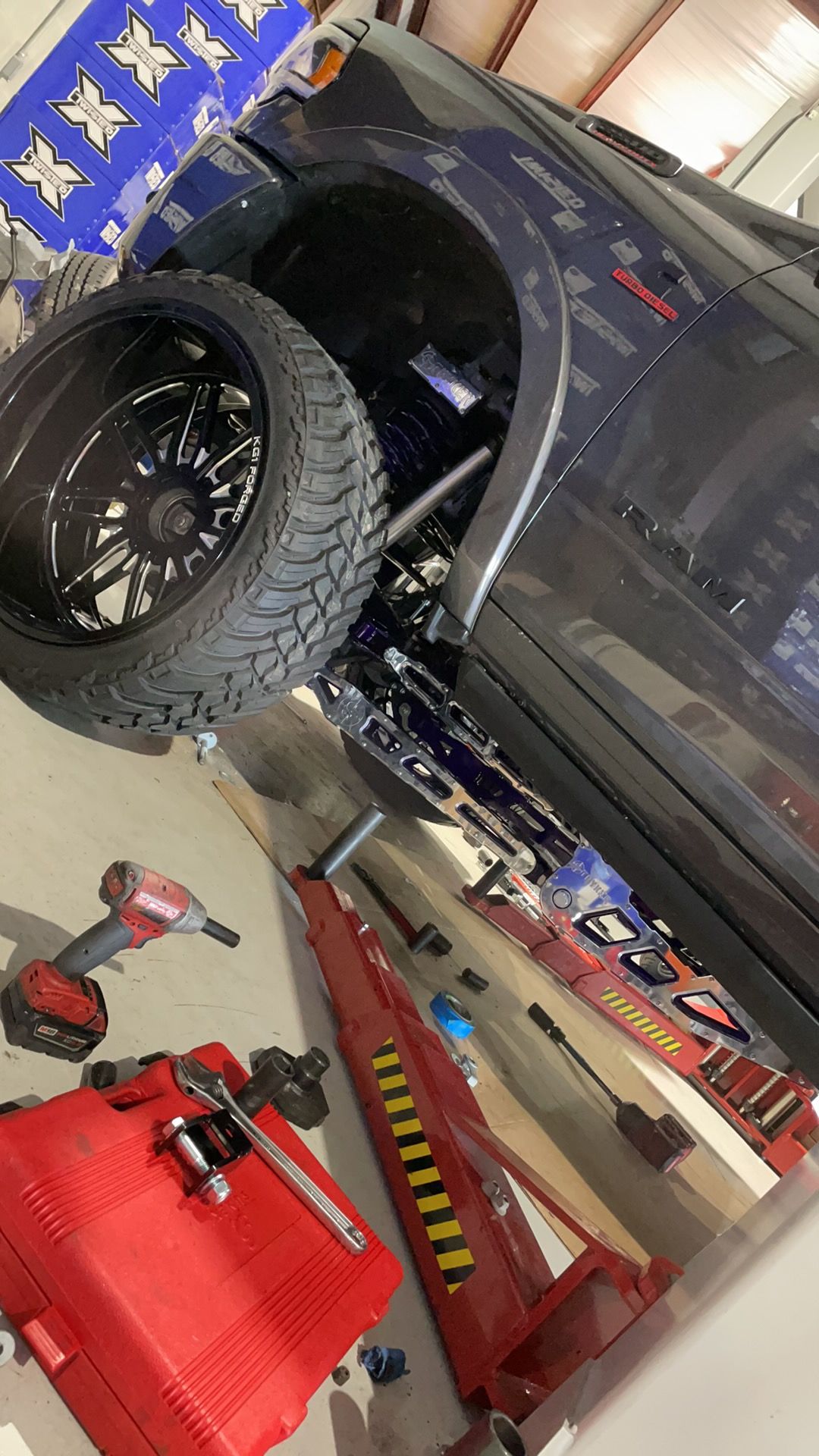A truck is being worked on in a garage.