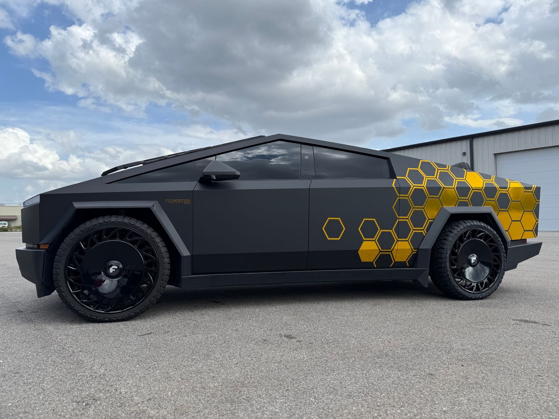 A white corvette convertible is parked in front of a building.