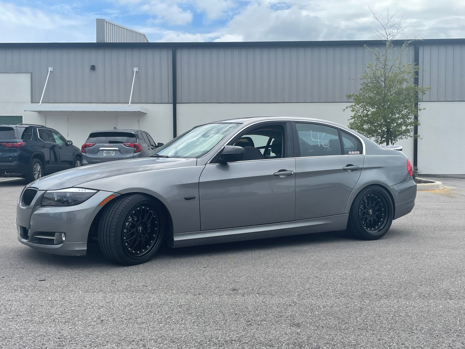 A black sports car is parked in front of a building.