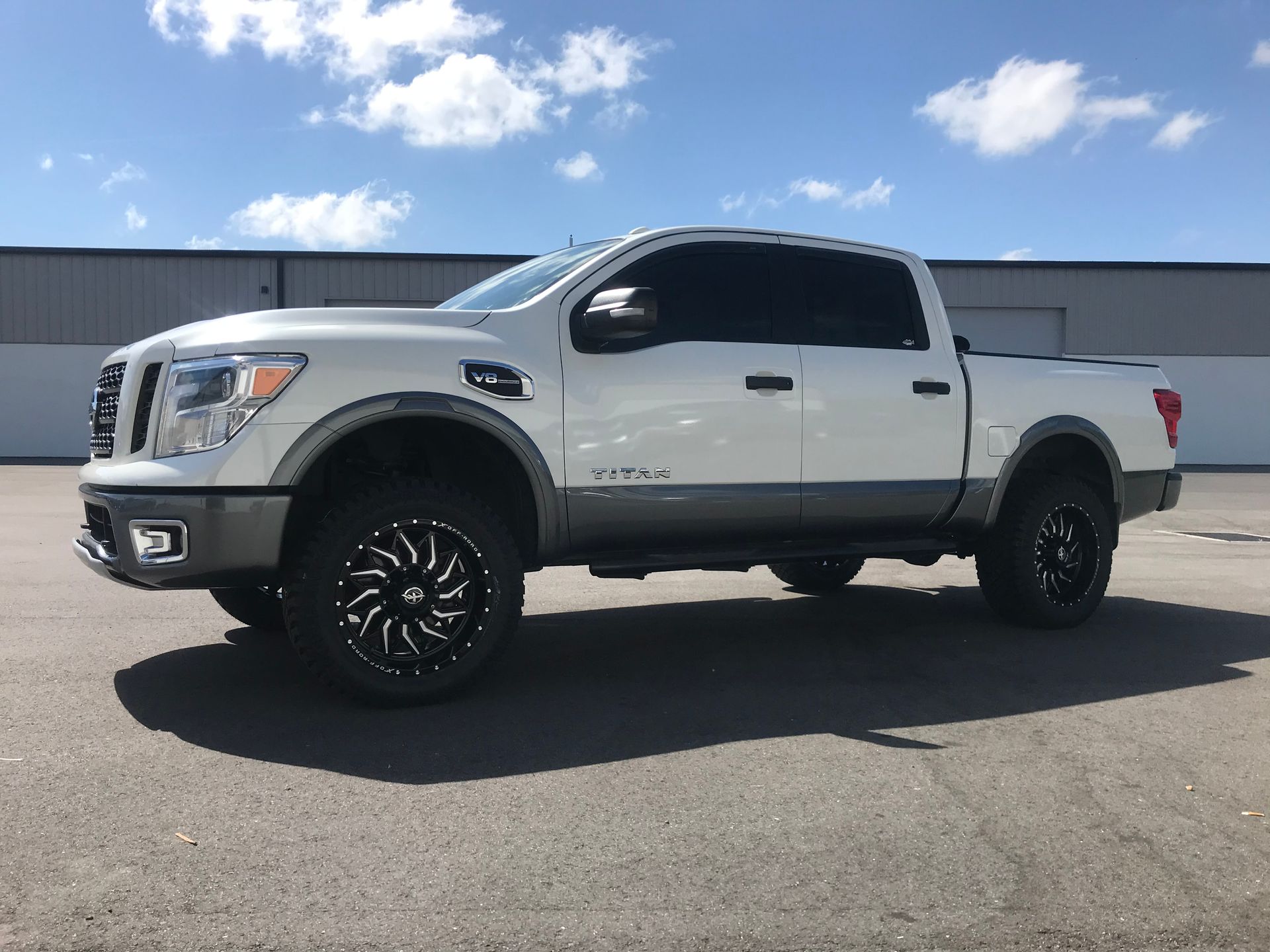 A white truck is parked on the side of the road.