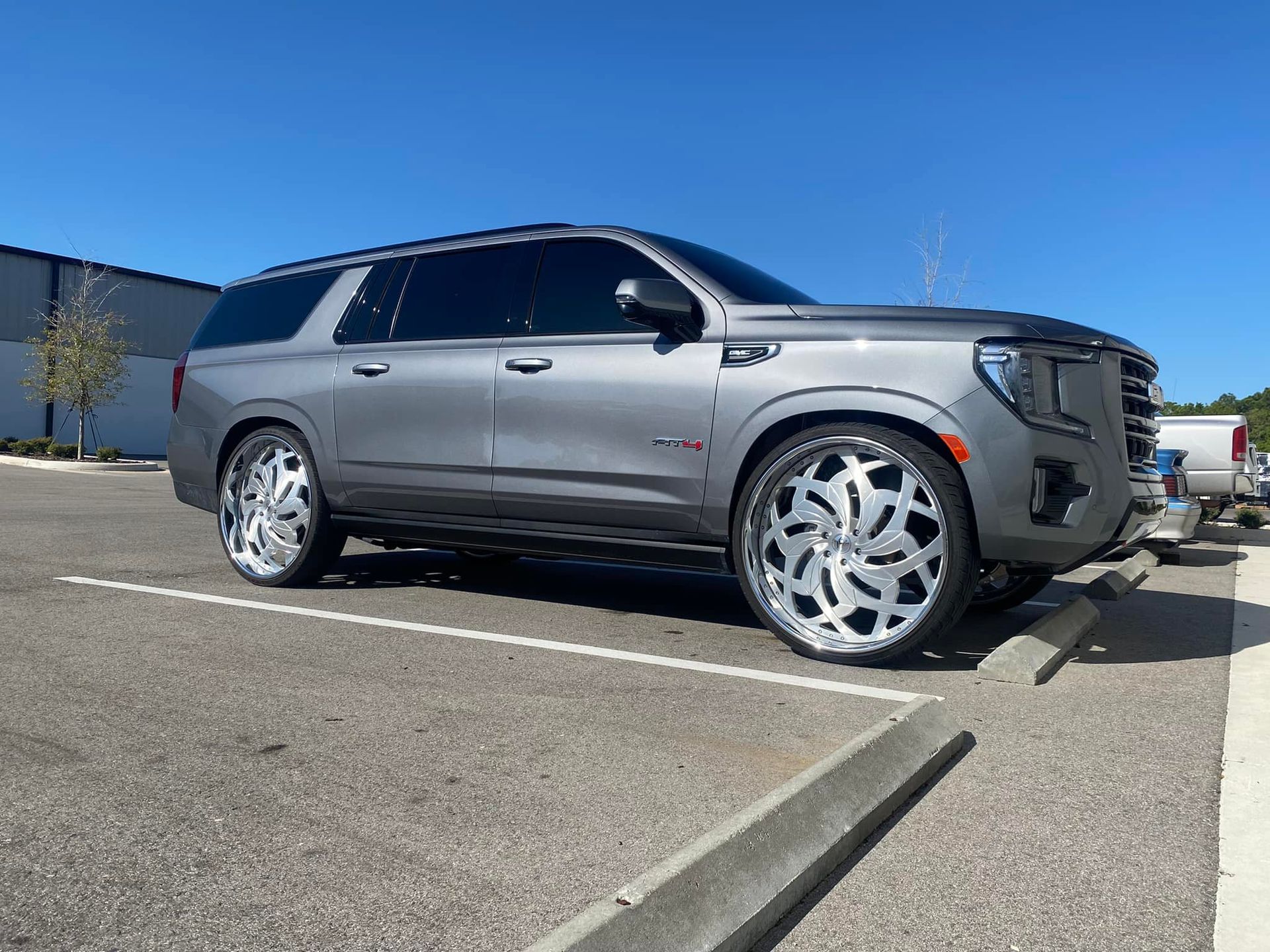 A gray suv is parked in a parking lot.