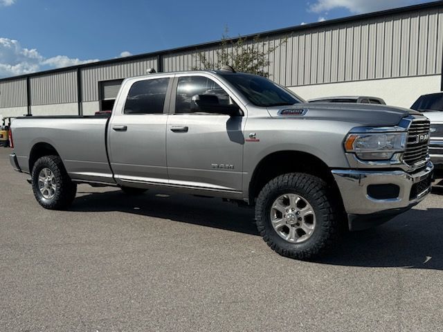 Silver Ram 2500 heavy duty pickup truck parked outside a building on a sunny day.