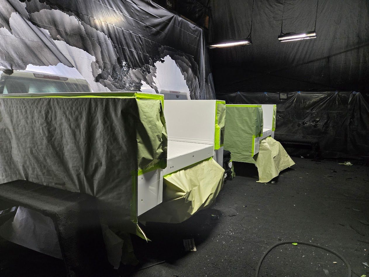 Workshop interior with white objects masked in yellow and gray for painting.