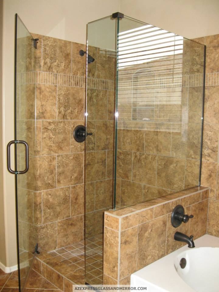 A bathroom with a walk in shower and a bathtub