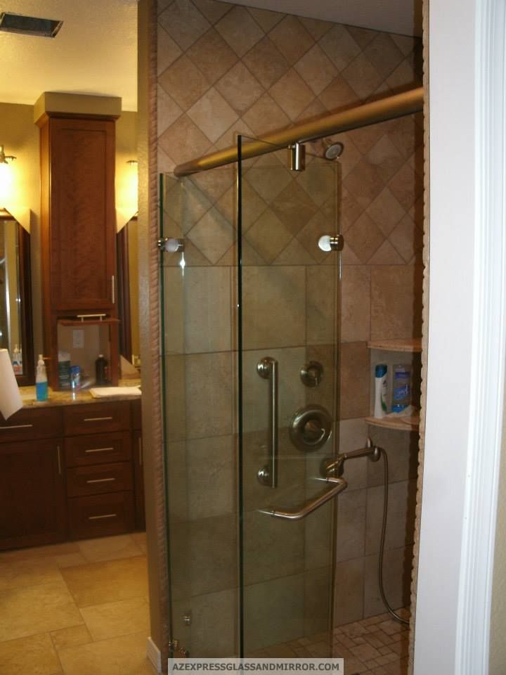 A bathroom with a sliding glass shower door
