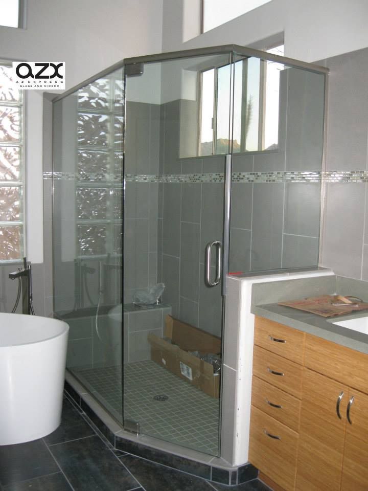 A bathroom with a walk in shower and a bathtub
