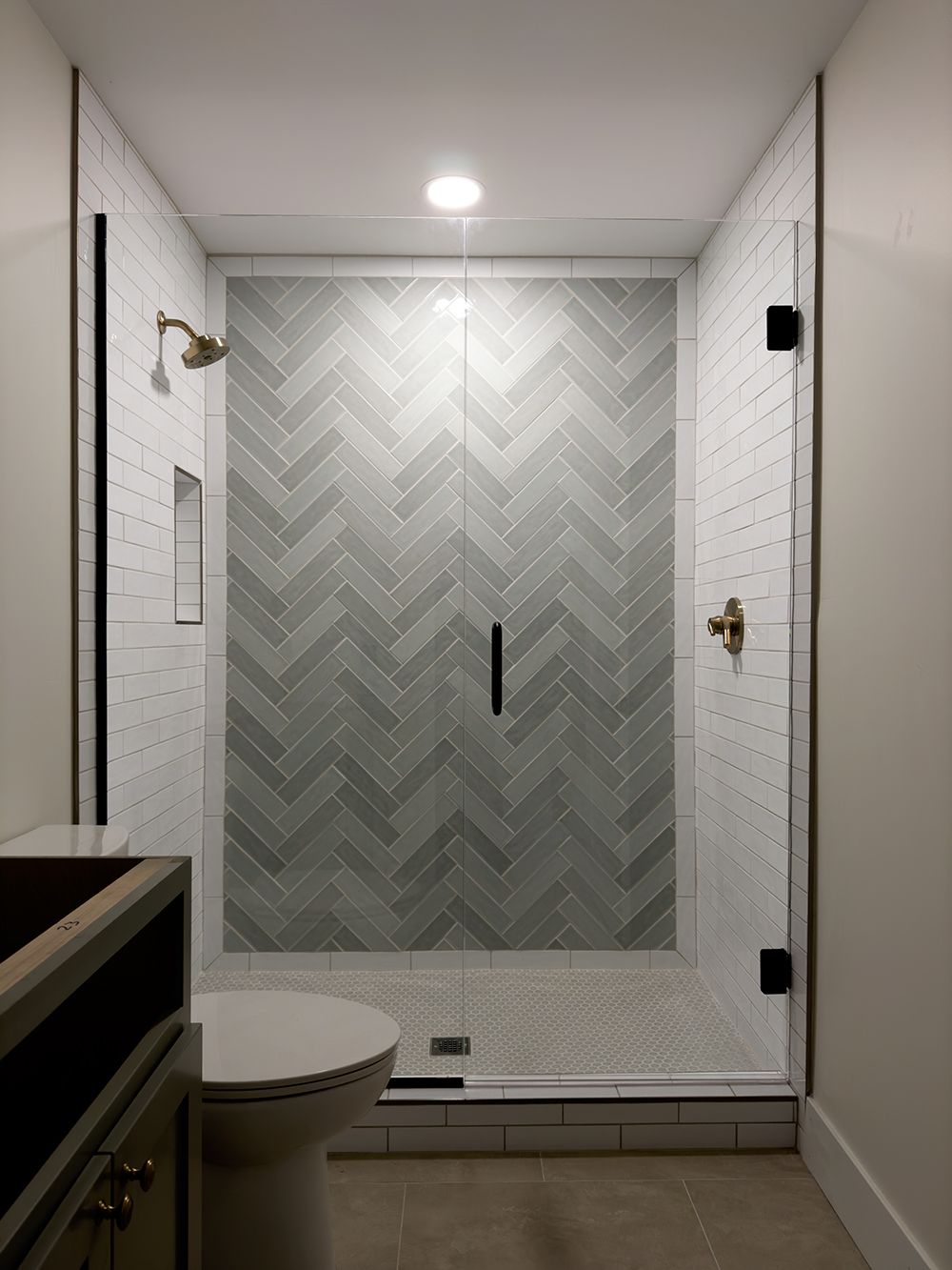 A bathroom with a walk in shower and a toilet.