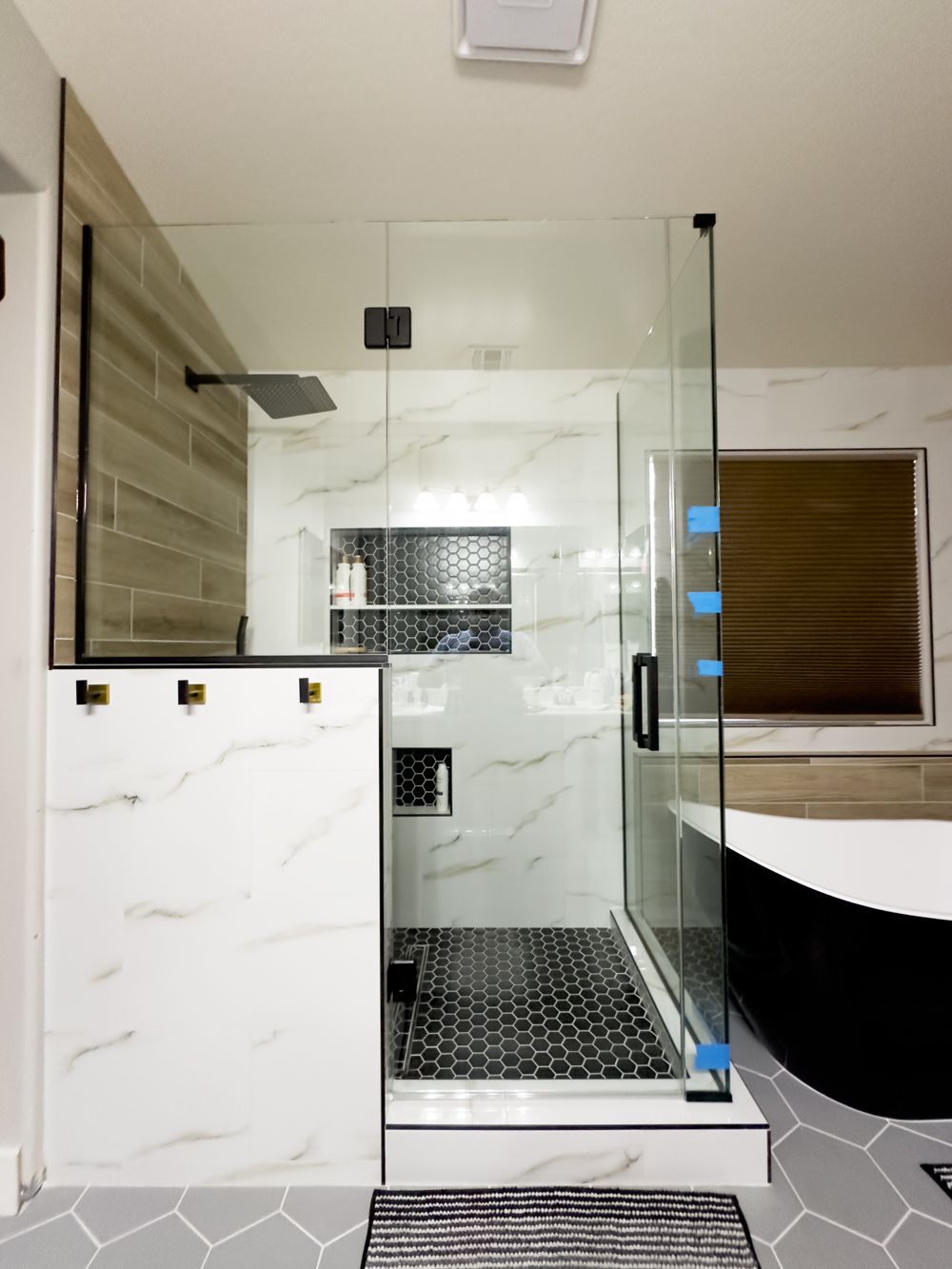 A bathroom with a walk in shower and a bathtub.