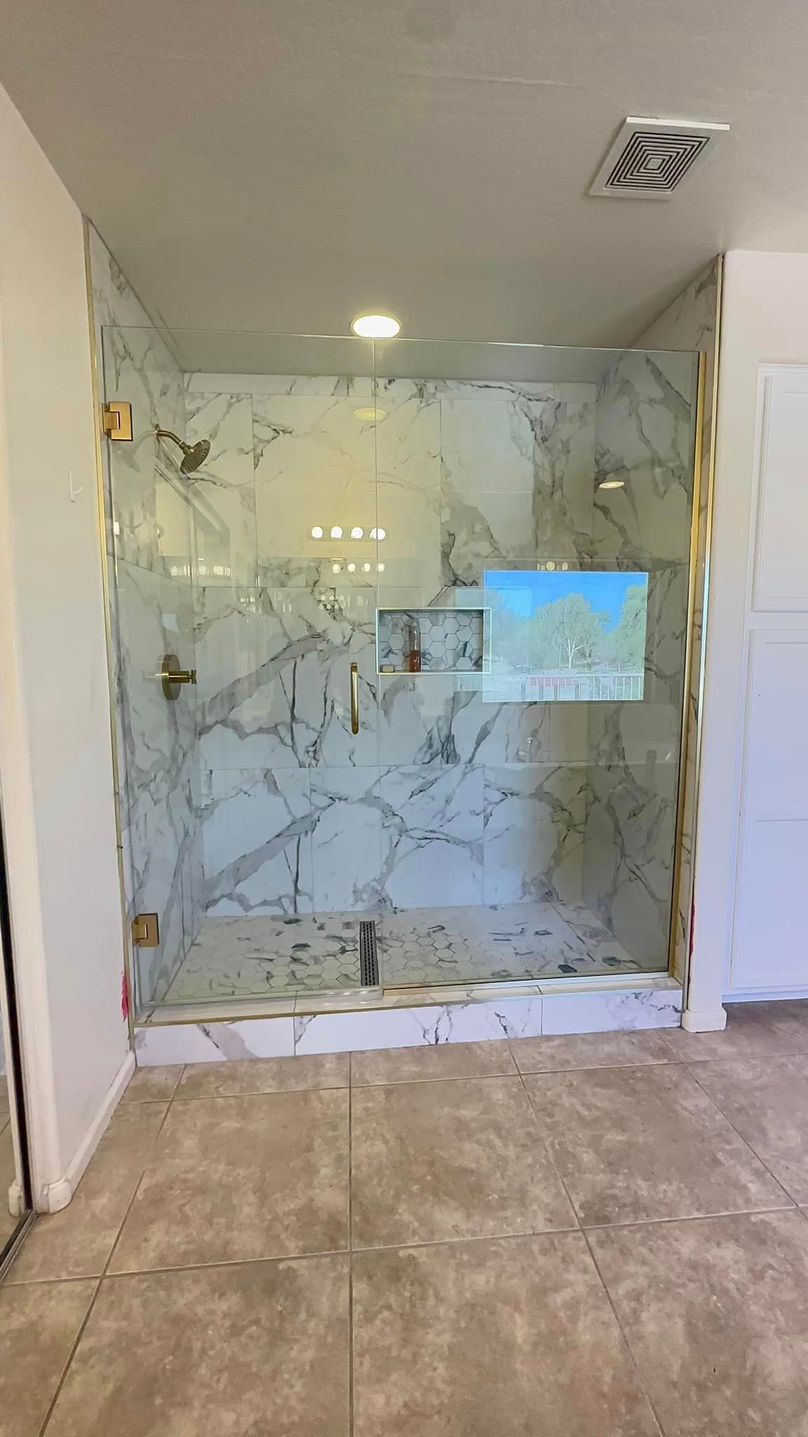 A bathroom with a walk in shower
