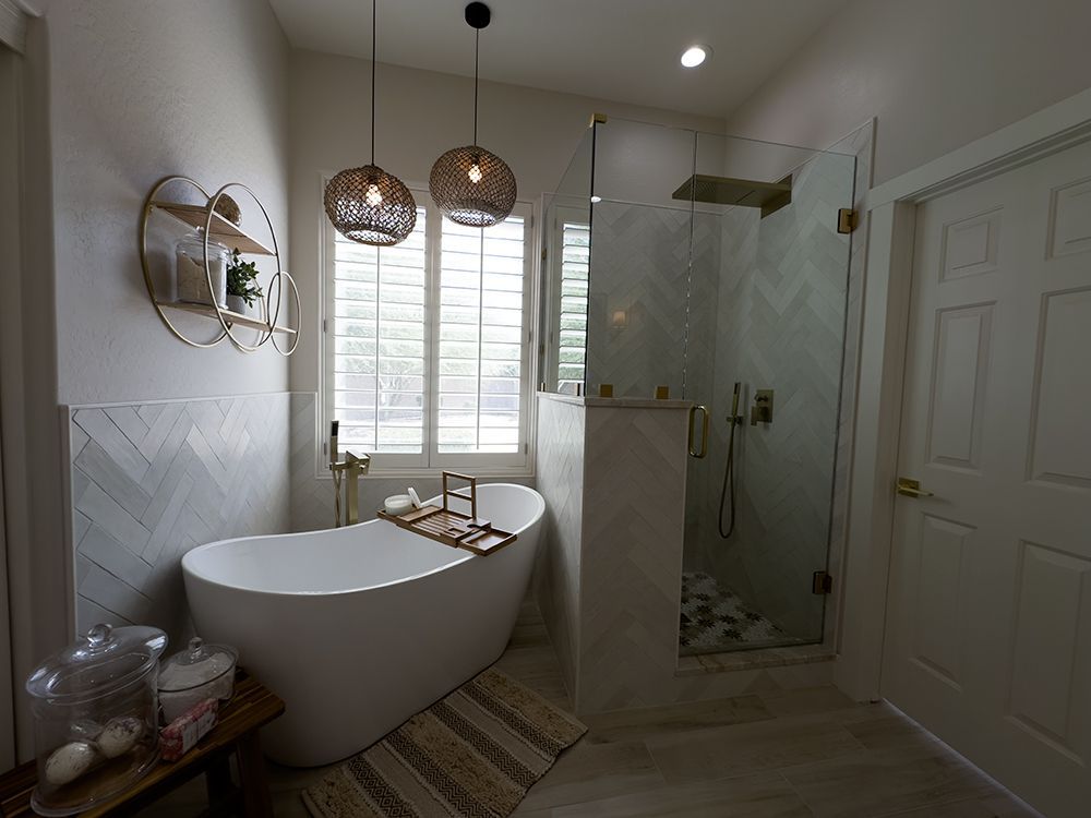A bathroom with a bathtub and a walk in shower.