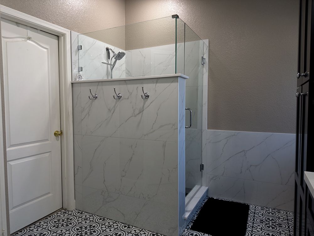 A bathroom with a walk in shower and a door.