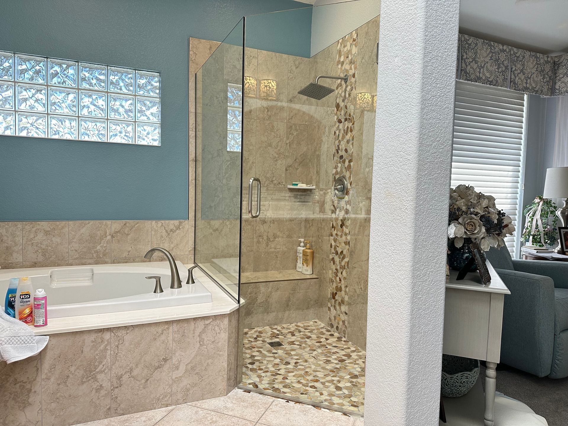A bathroom with a tub and a walk in shower.