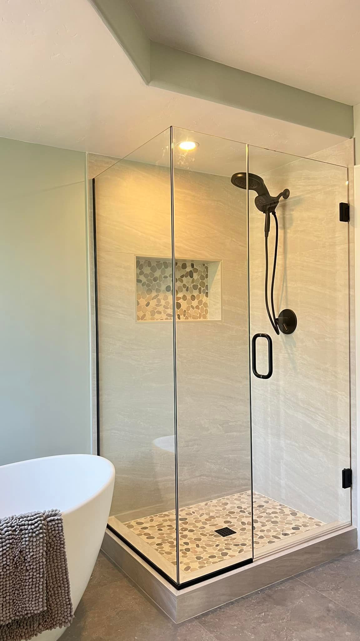 A bathroom with a walk in shower and a bathtub.