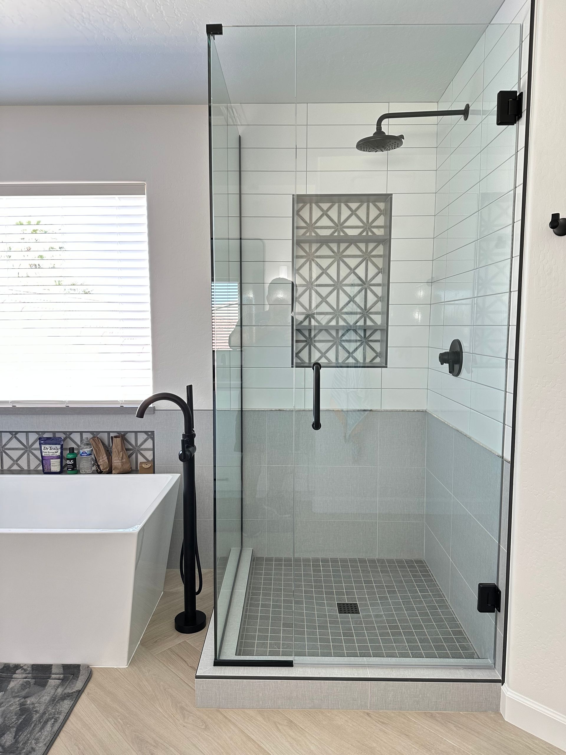 A bathroom with a walk in shower and a bathtub.