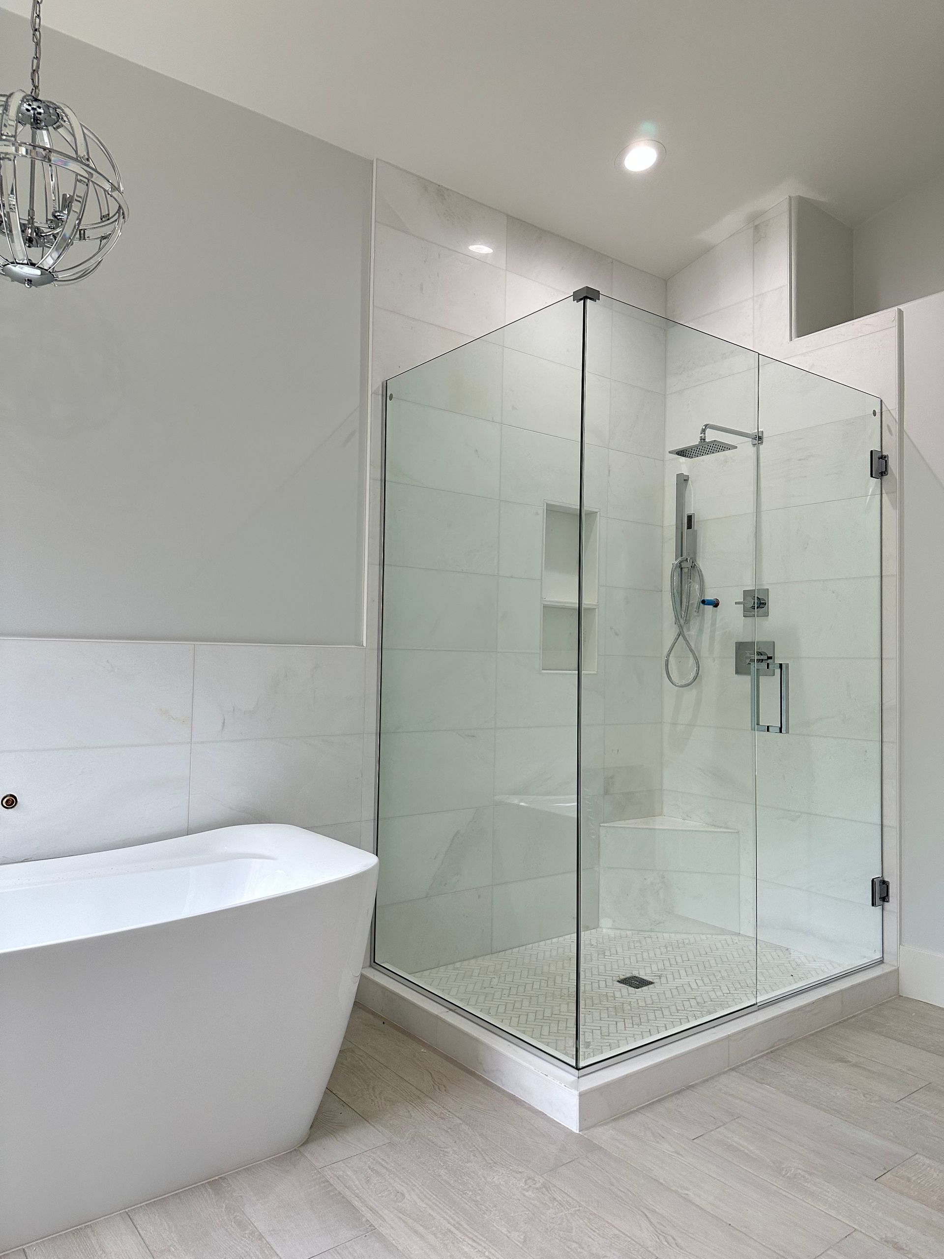 A bathroom with a bathtub and a walk in shower.