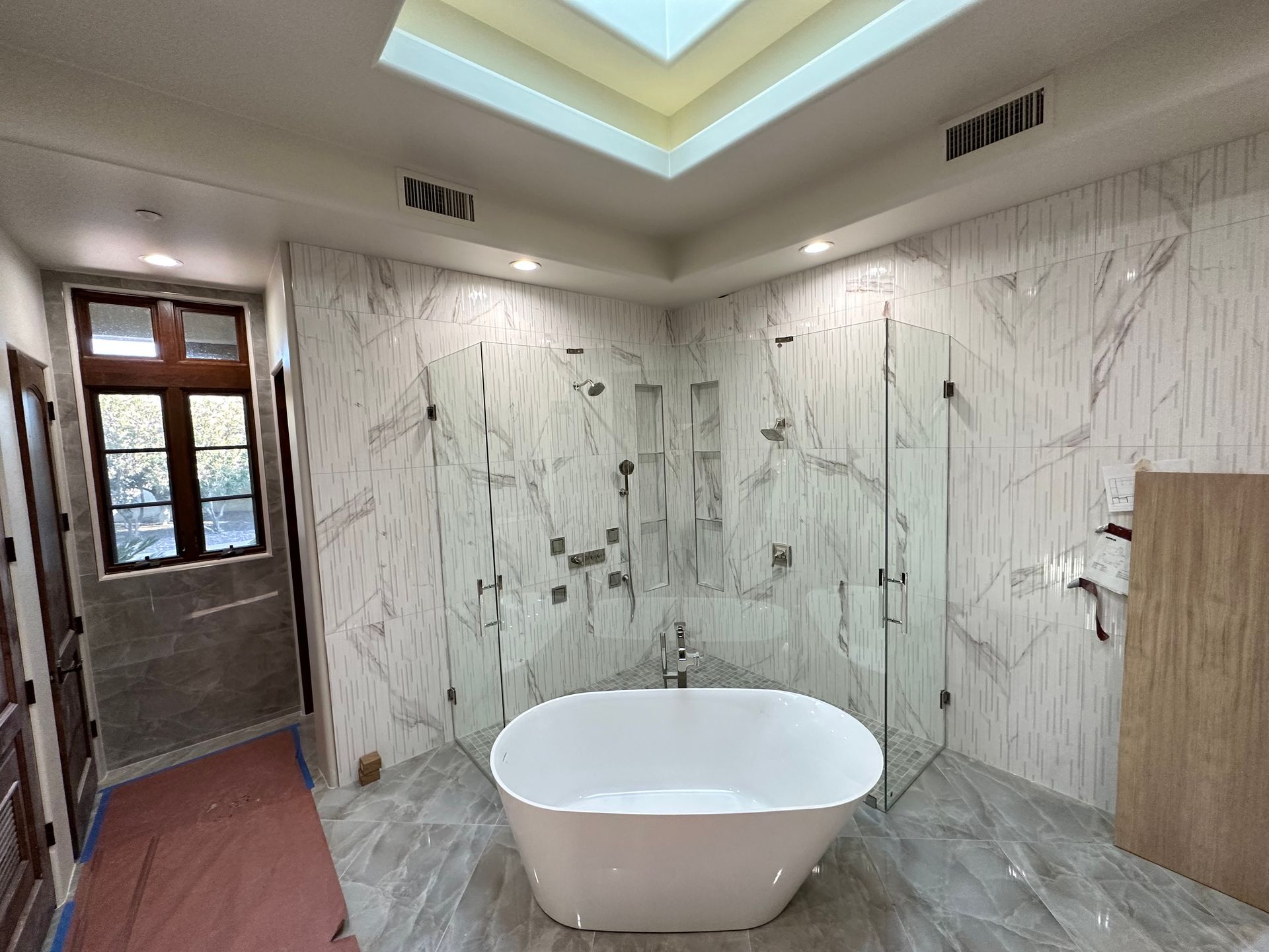 There is a bathtub in the middle of the bathroom.