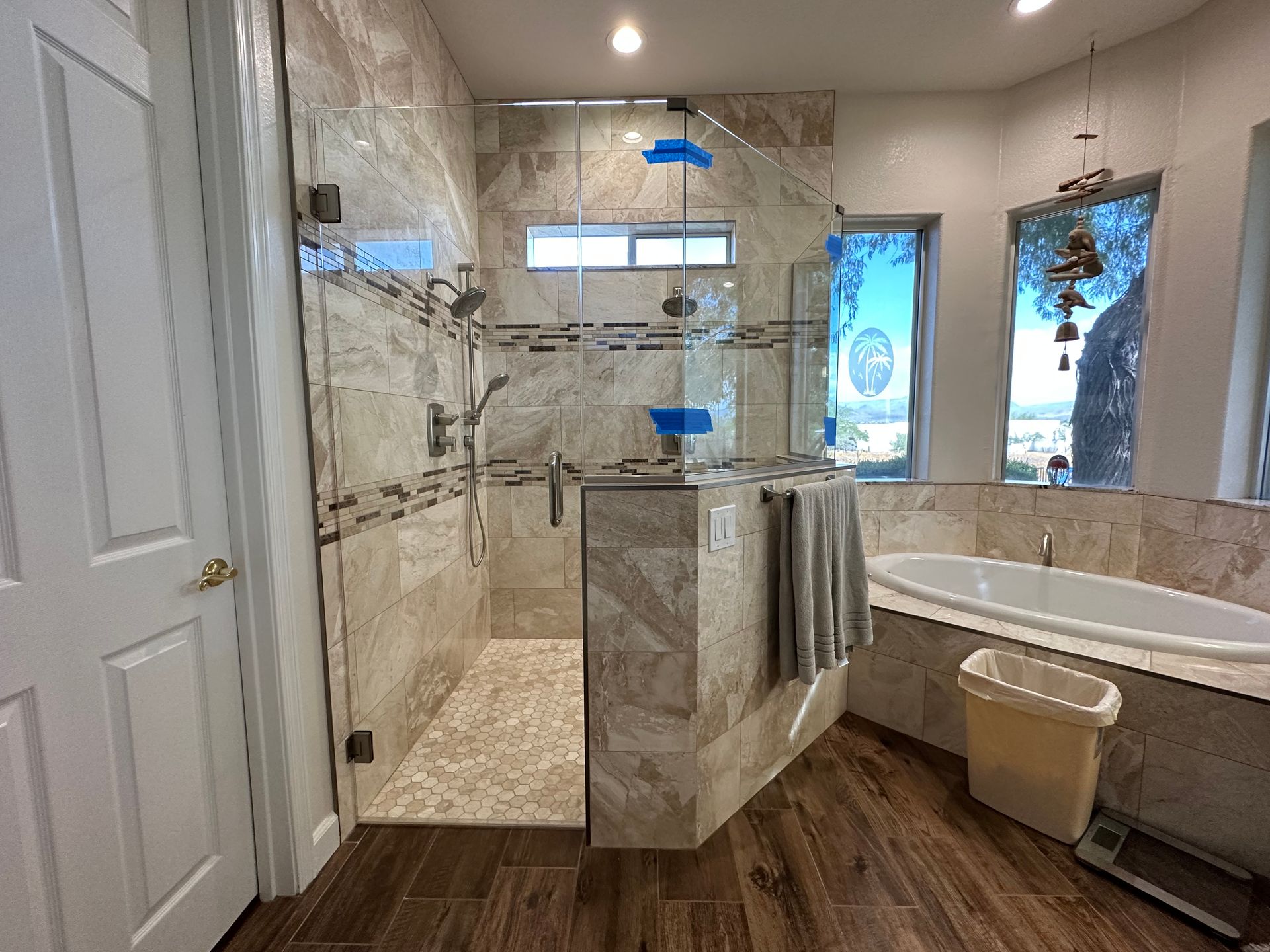 A bathroom with a tub, shower, and window.
