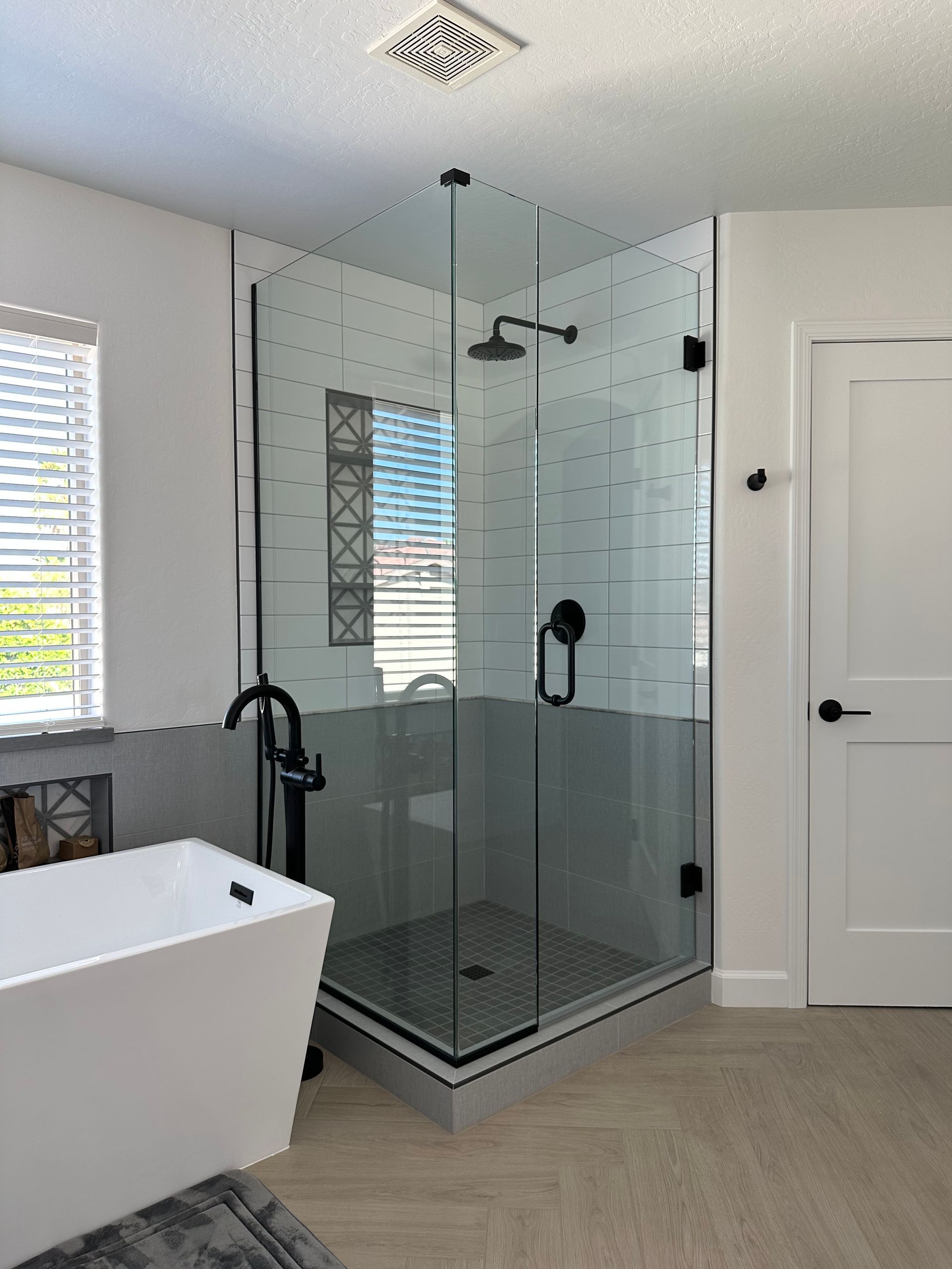 A bathroom with a bathtub and a walk in shower.