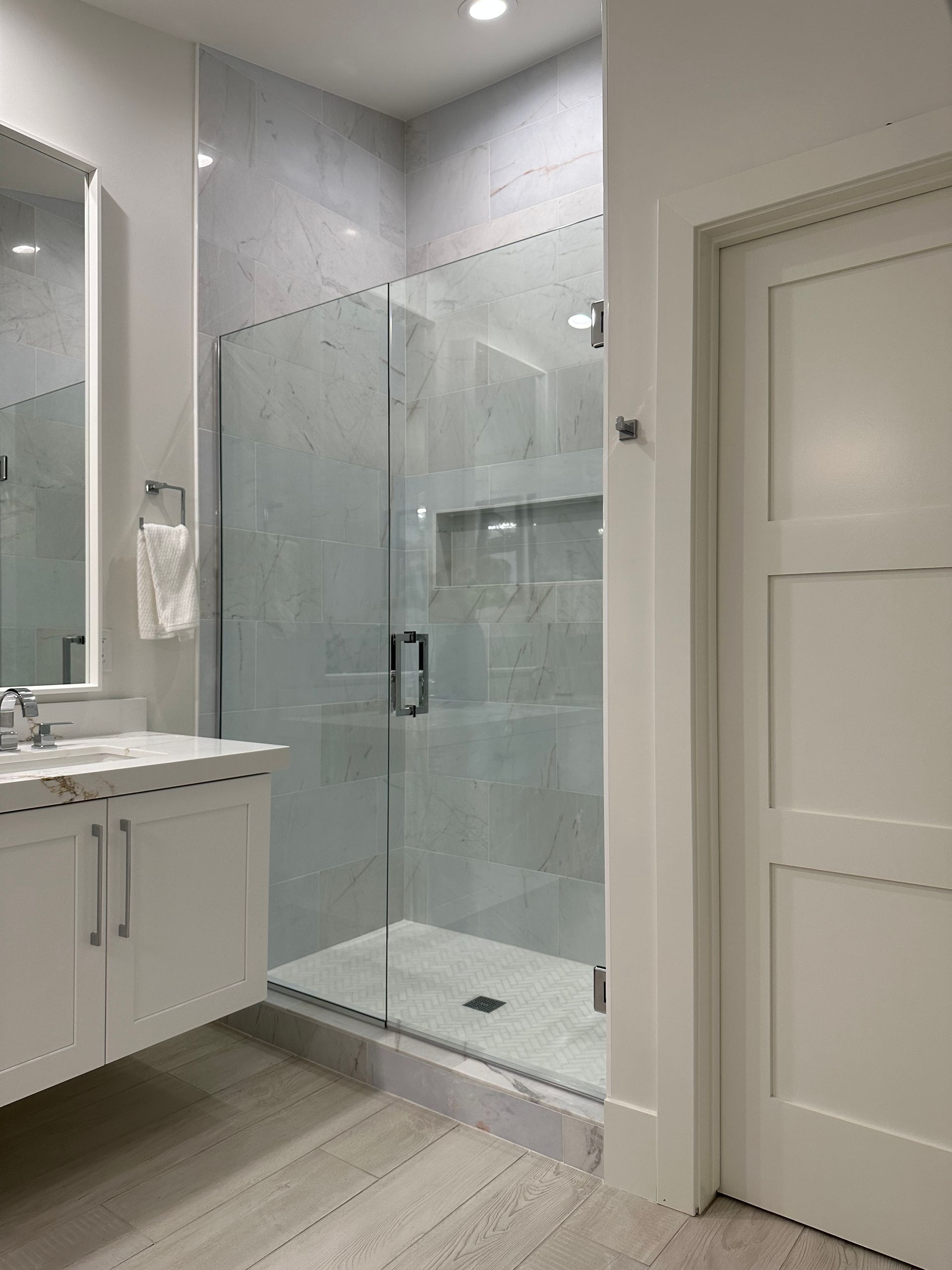 A bathroom with a walk in shower and a toilet.