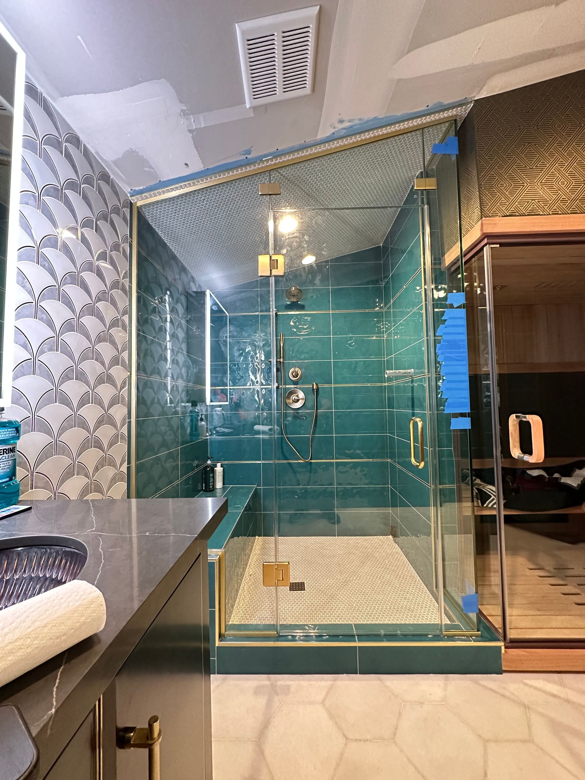 A bathroom with a walk in shower and a sauna.