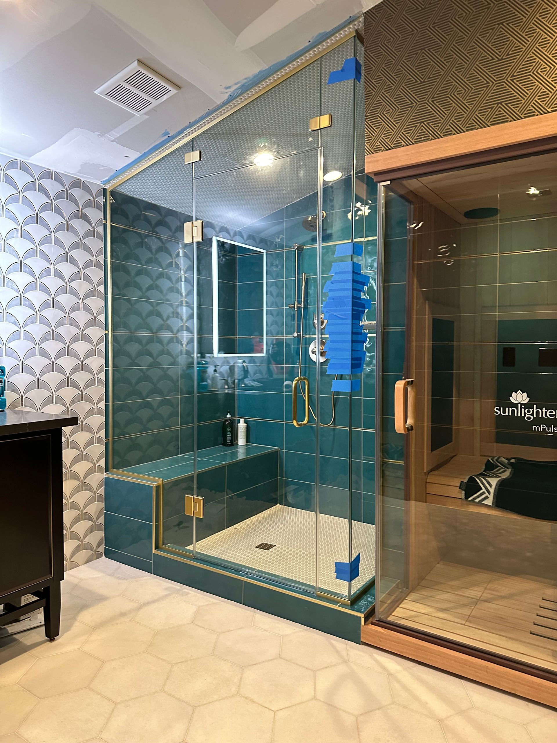 A bathroom with a walk in shower and a sauna.