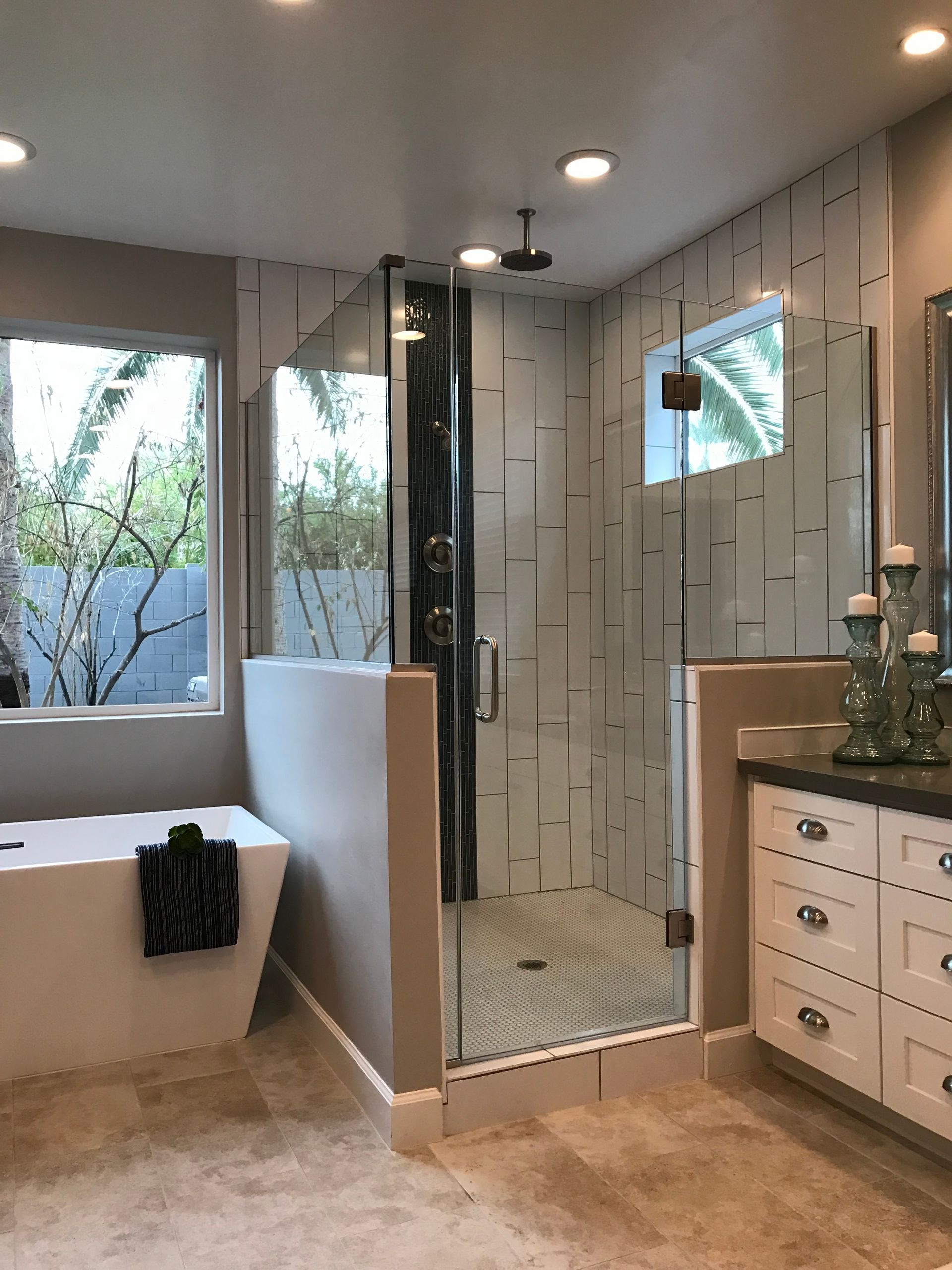A bathroom with a bathtub and a walk in shower.