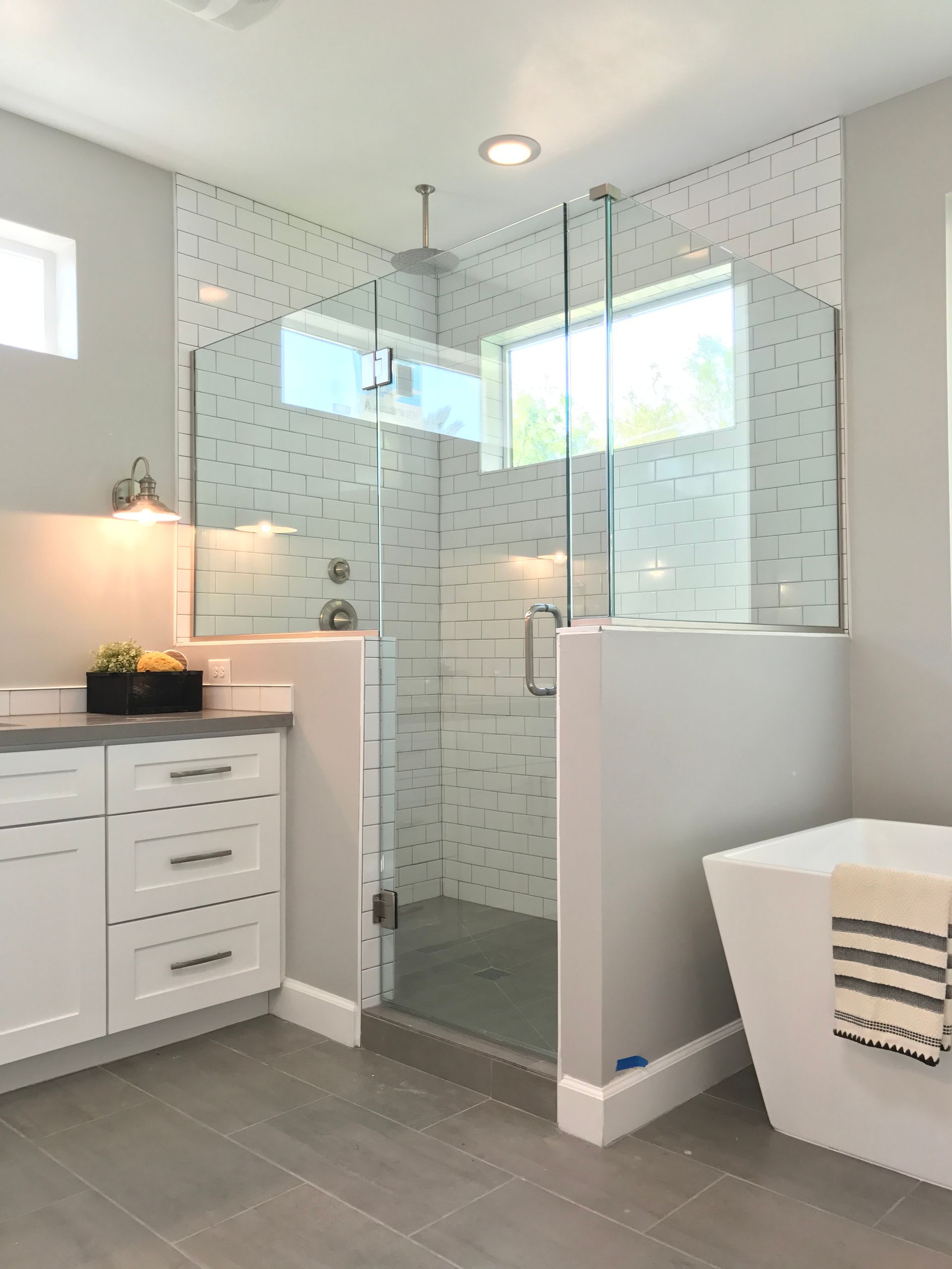 A bathroom with a walk in shower and a bathtub.