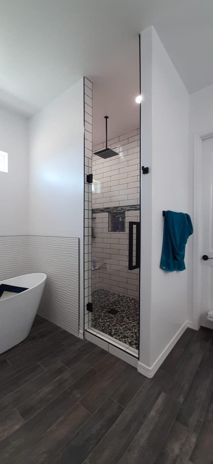 A bathroom with a walk in shower and a bathtub.