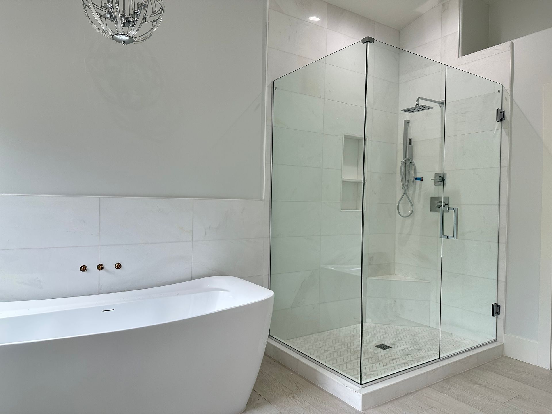 A bathroom with a bathtub and a walk in shower.