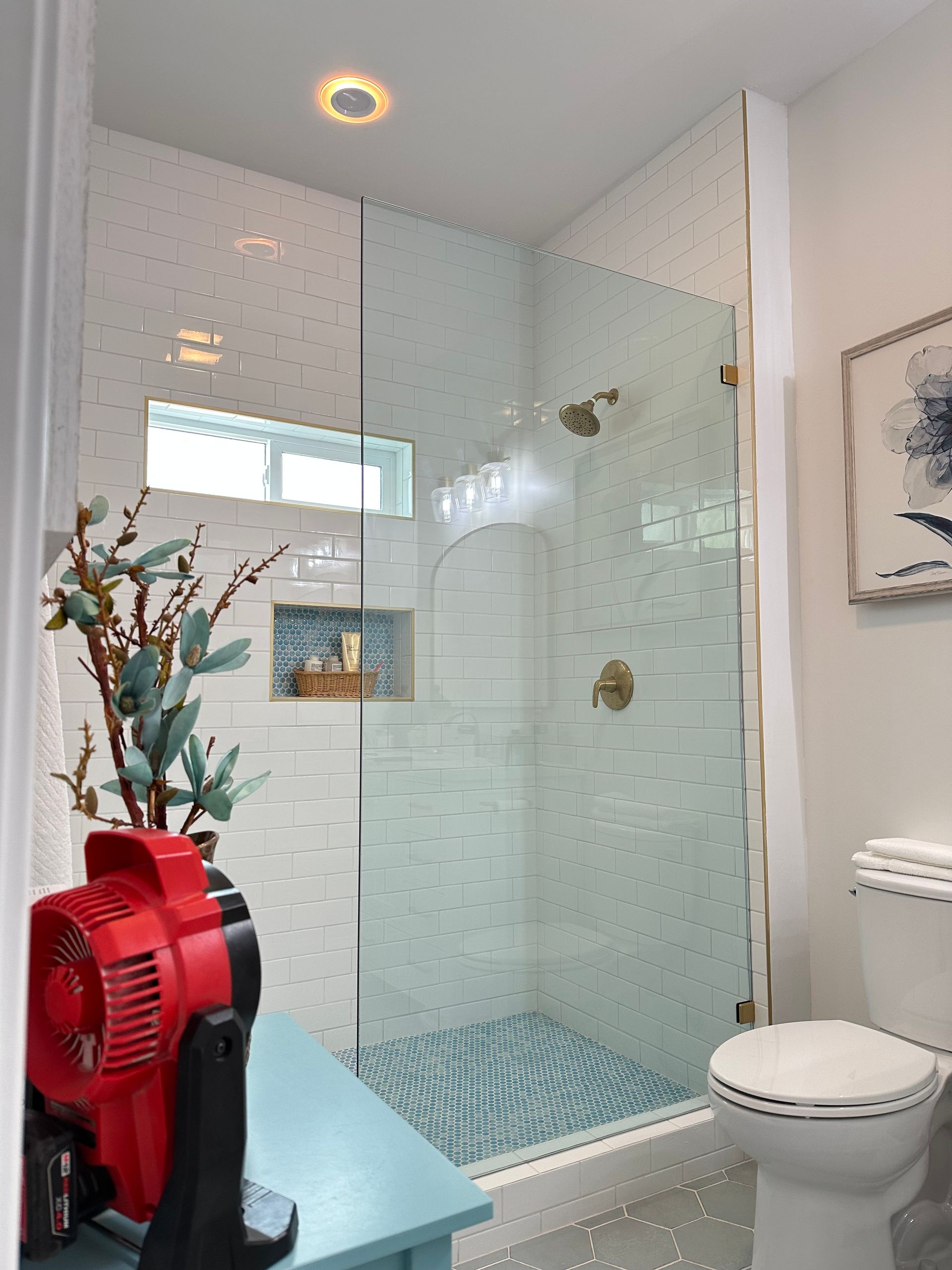 A bathroom with a walk in shower and a toilet.