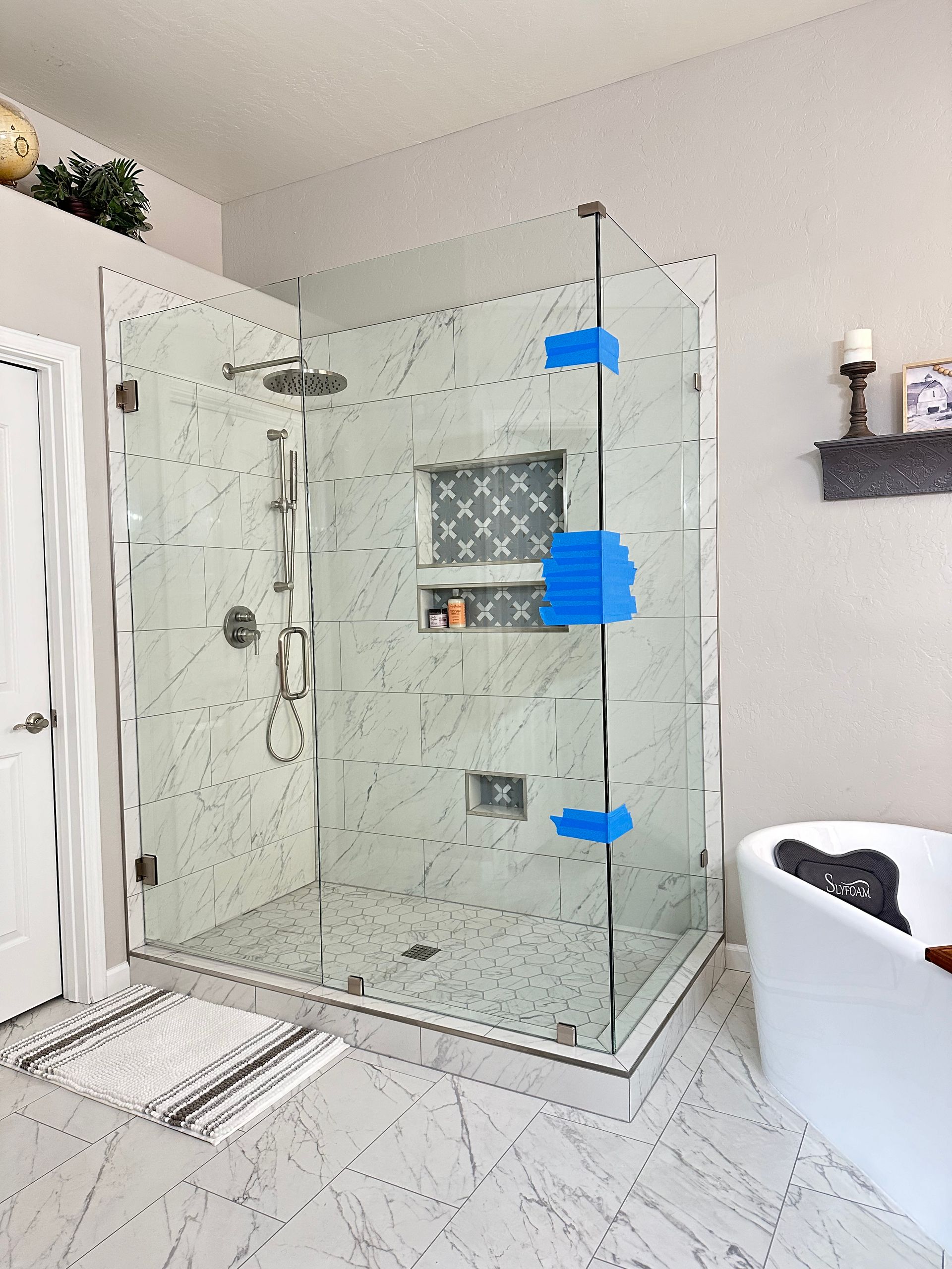 A bathroom with a walk in shower and a bathtub.