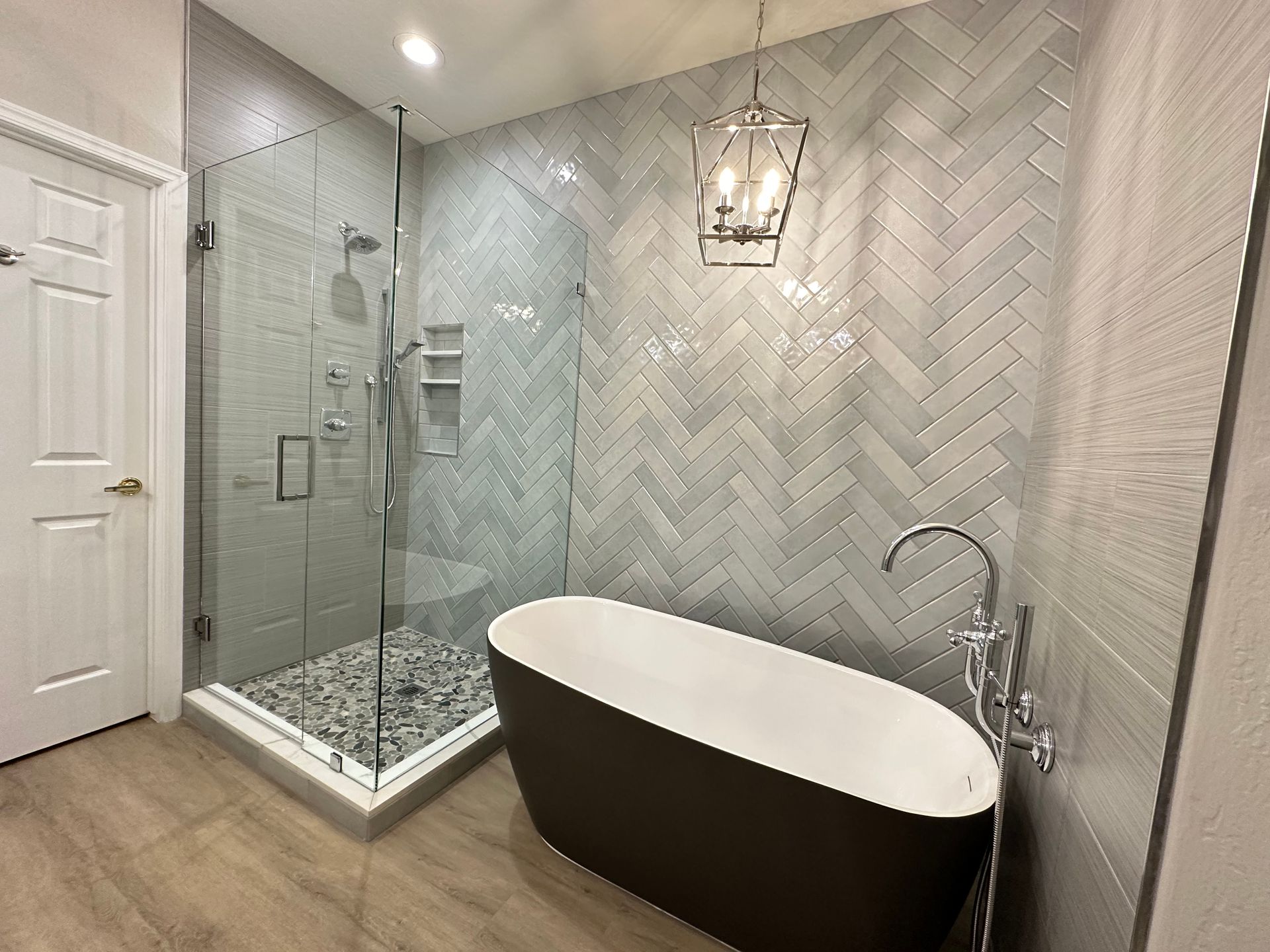 A bathroom with a bathtub and a walk in shower.