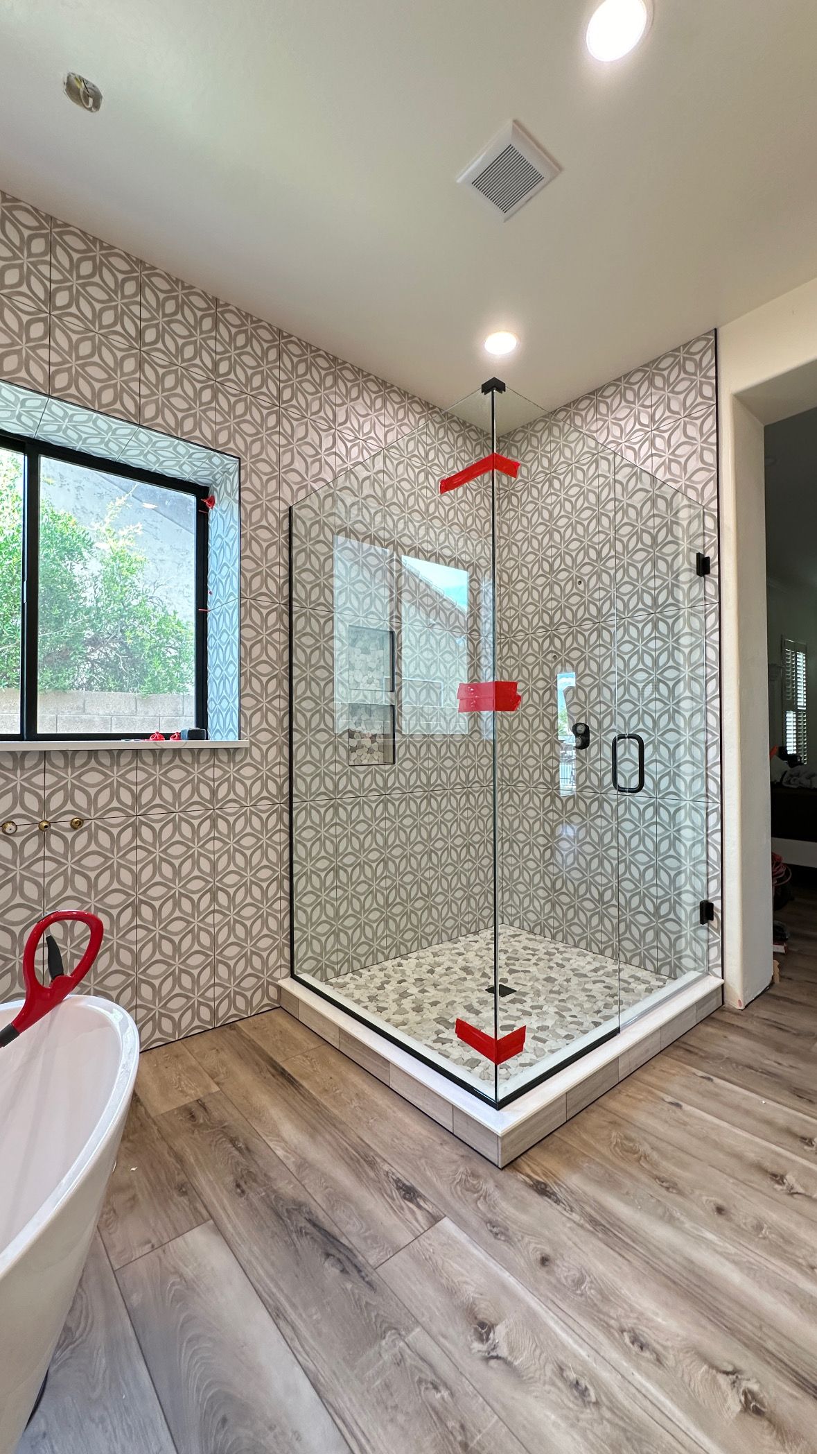 A bathroom with a walk in shower and a bathtub.