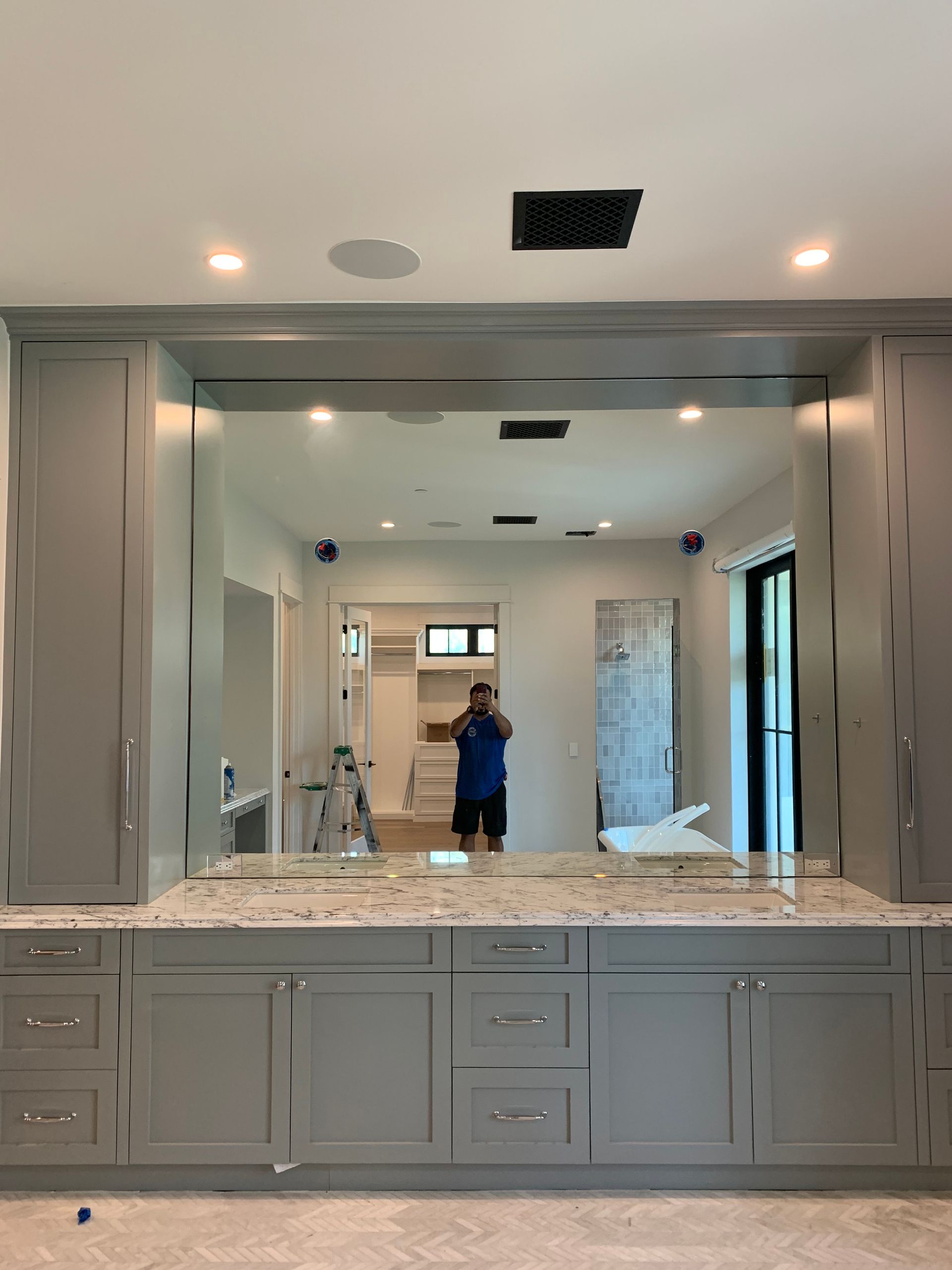 A man is taking a picture of himself in a bathroom mirror.