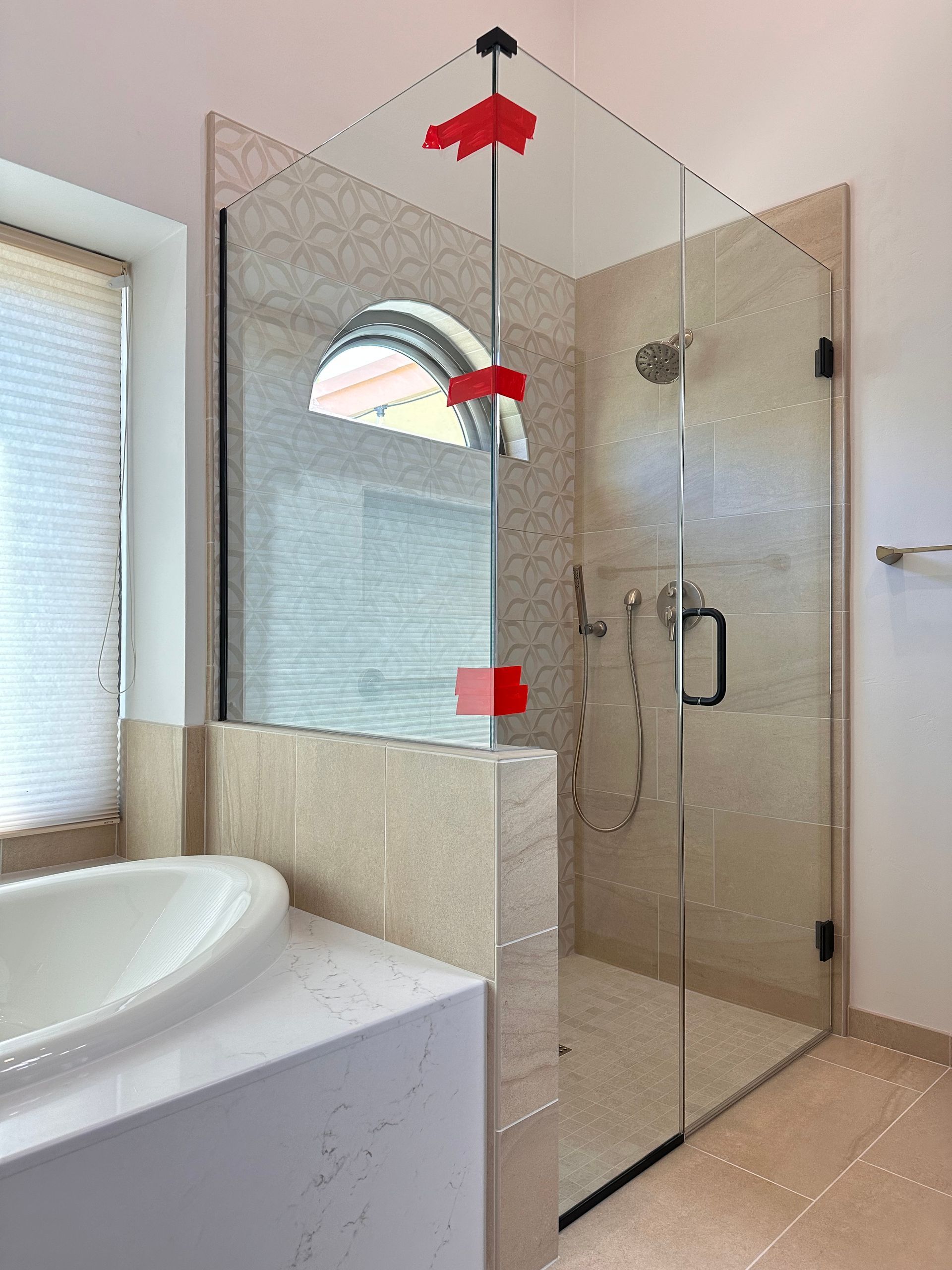 A bathroom with a walk in shower and a bathtub.