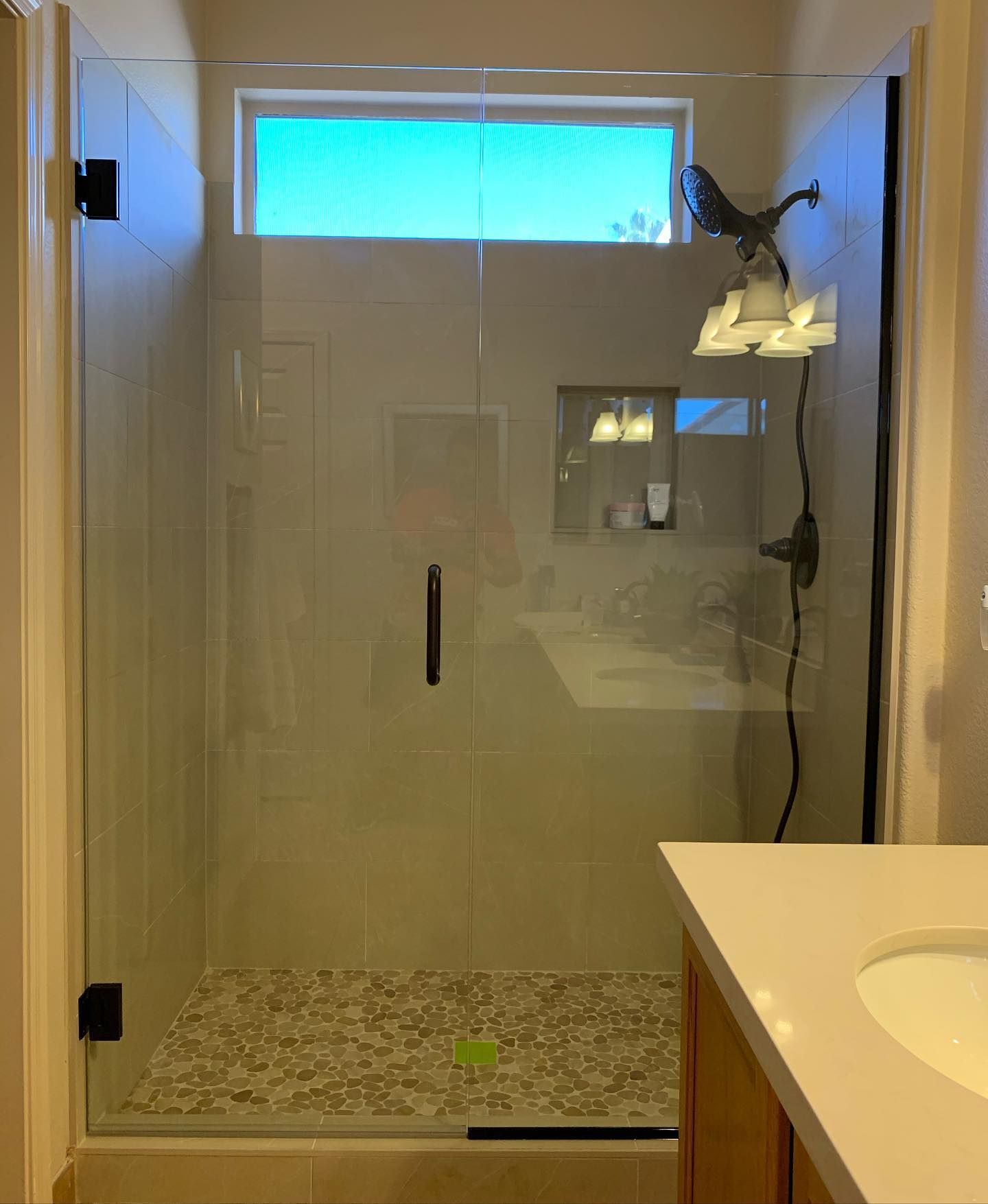 A bathroom with a walk in shower and a sink.