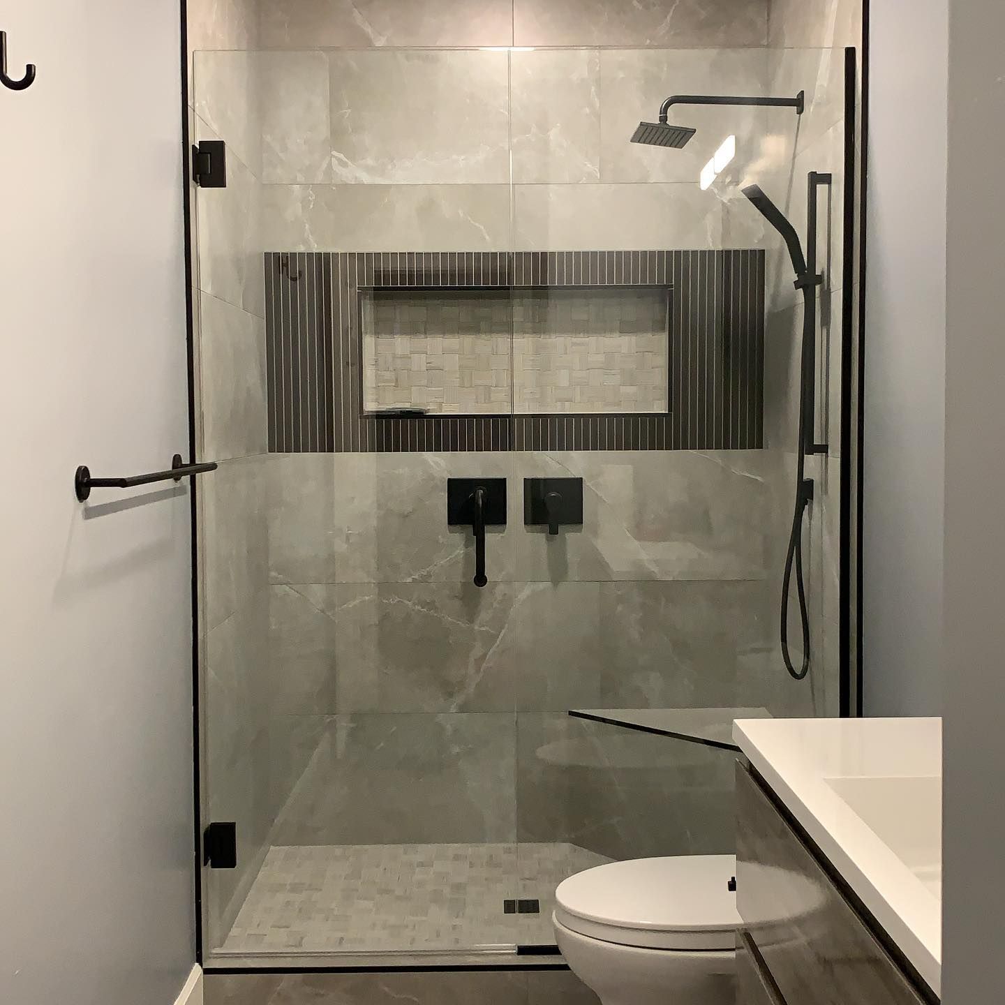 A bathroom with a walk in shower and a toilet