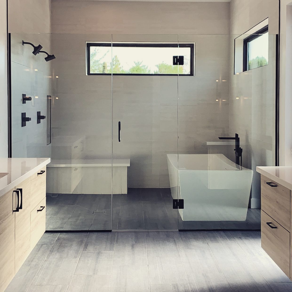 A bathroom with a bathtub and a window