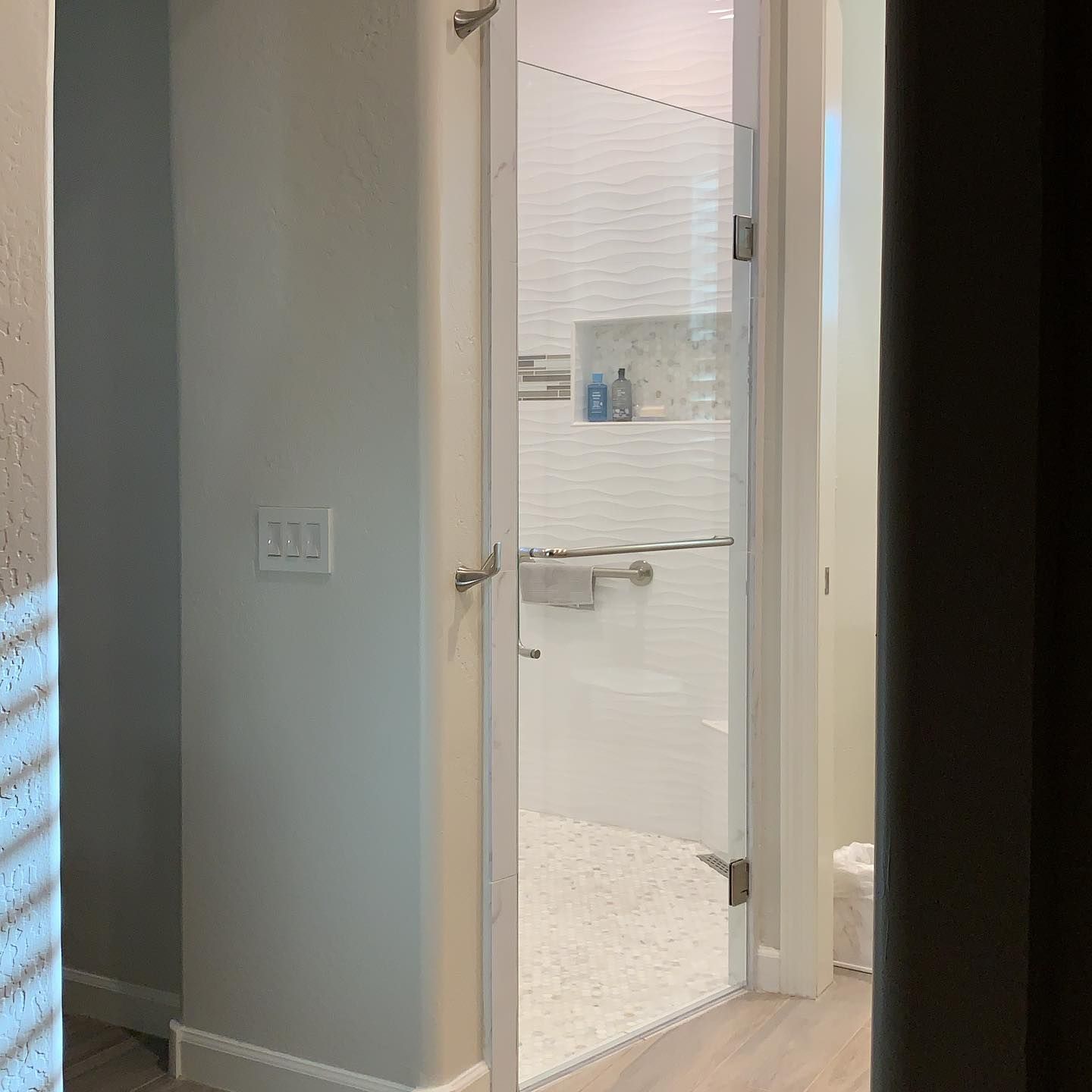 A bathroom with a walk in shower and a toilet.
