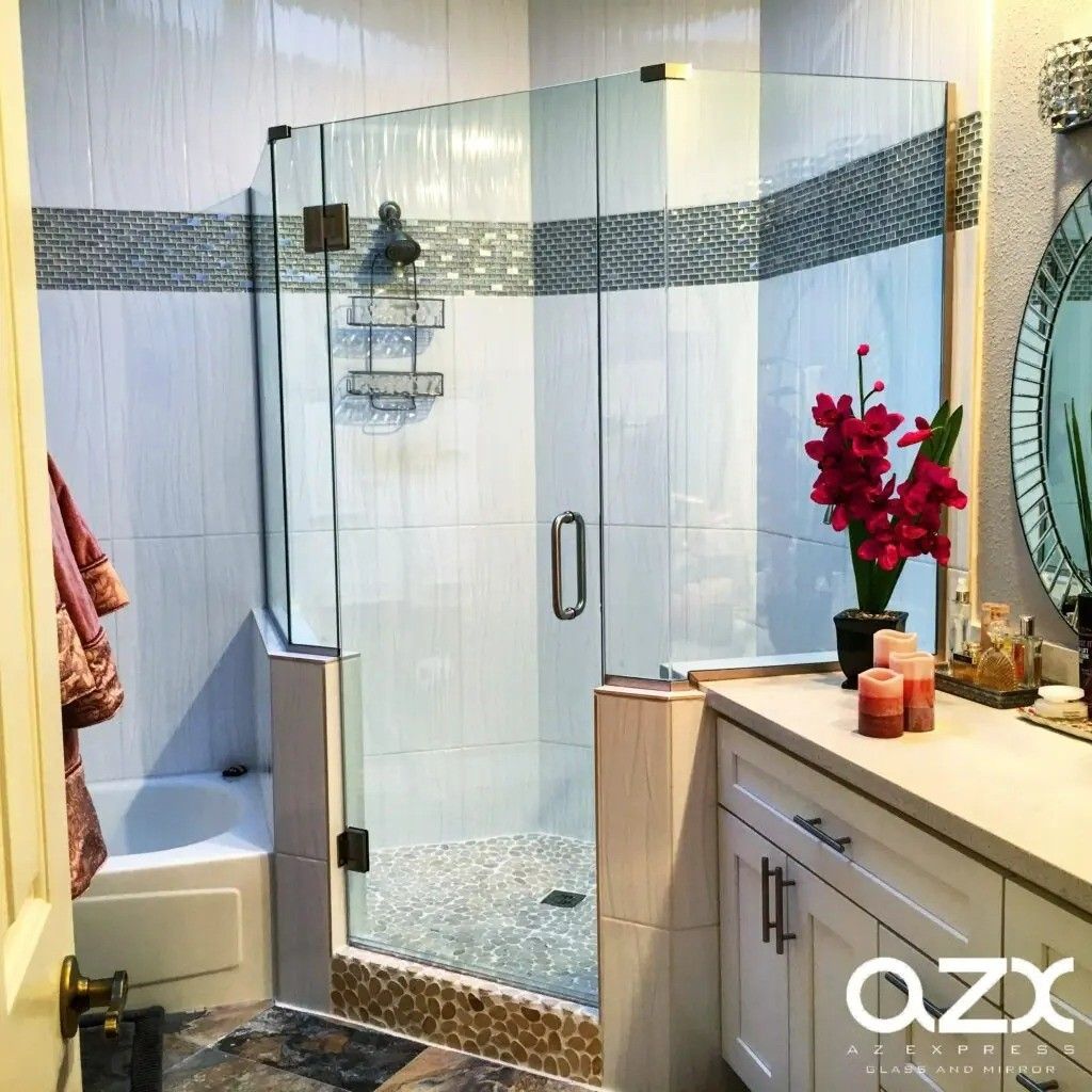 A bathroom with a walk in shower, tub, sink, and mirror.