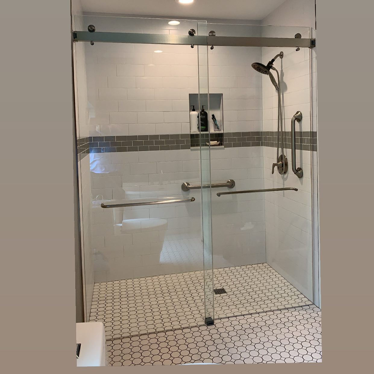 A bathroom with a sliding glass shower door