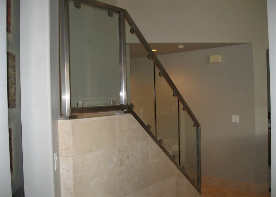 A staircase with a glass railing in a house.