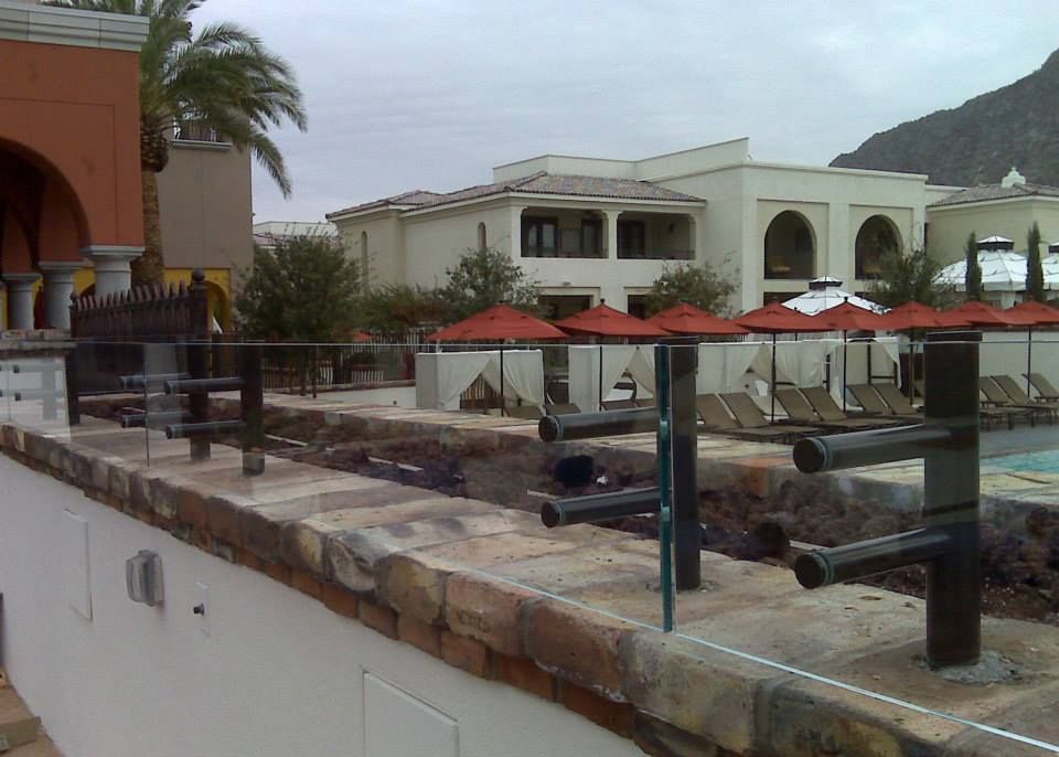 A large building with a pool and umbrellas in front of it