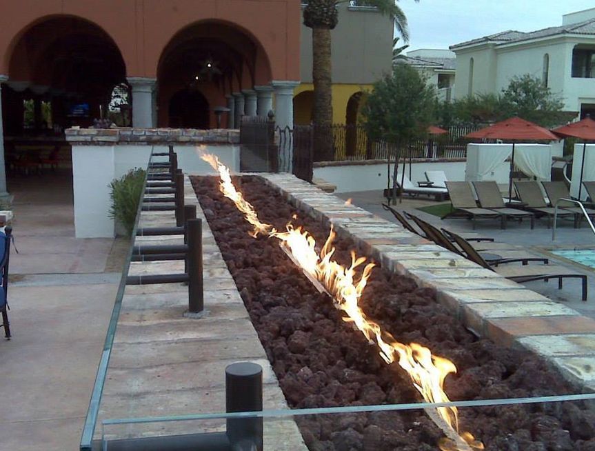 A fire pit with flames coming out of it