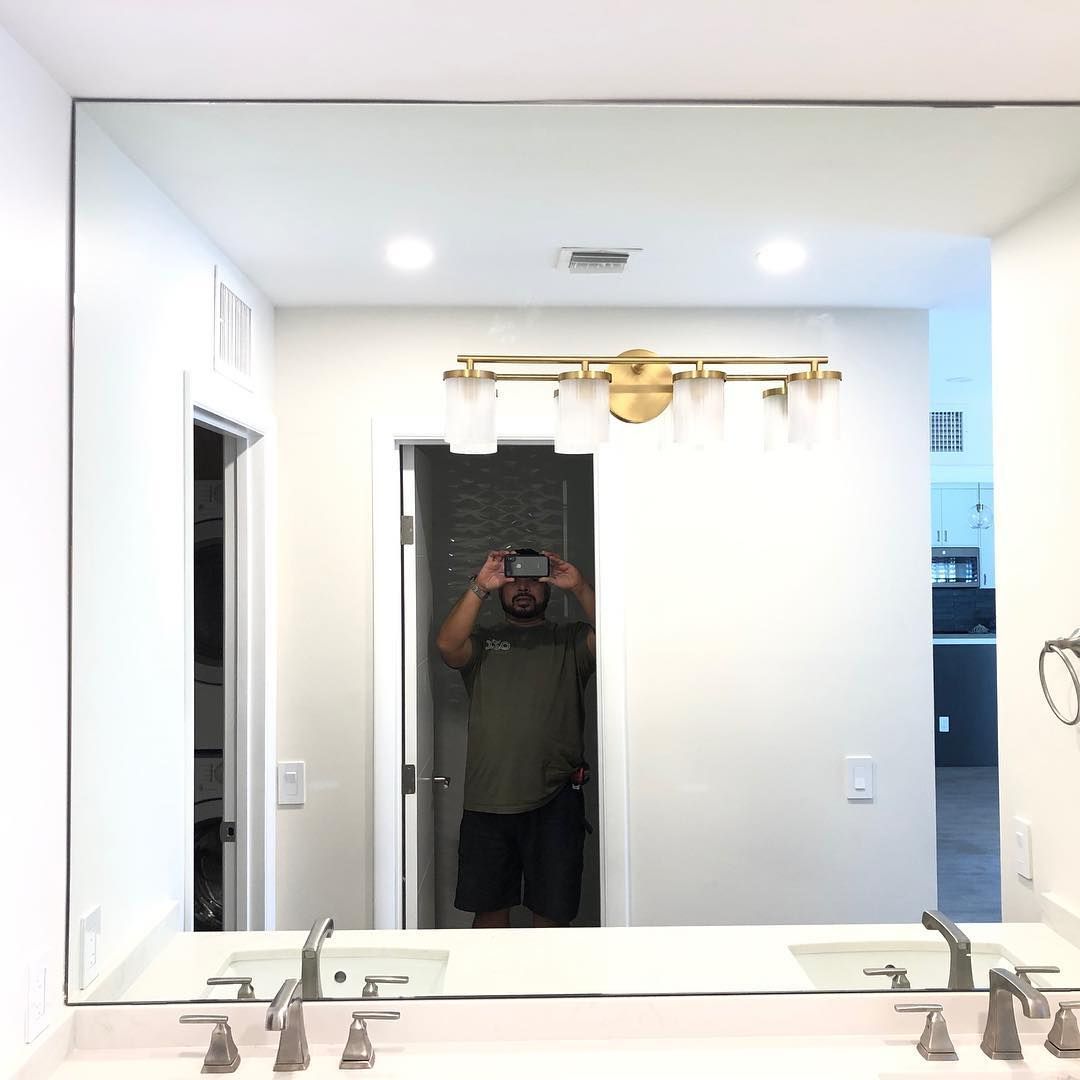 A man is taking a picture of himself in a bathroom mirror.